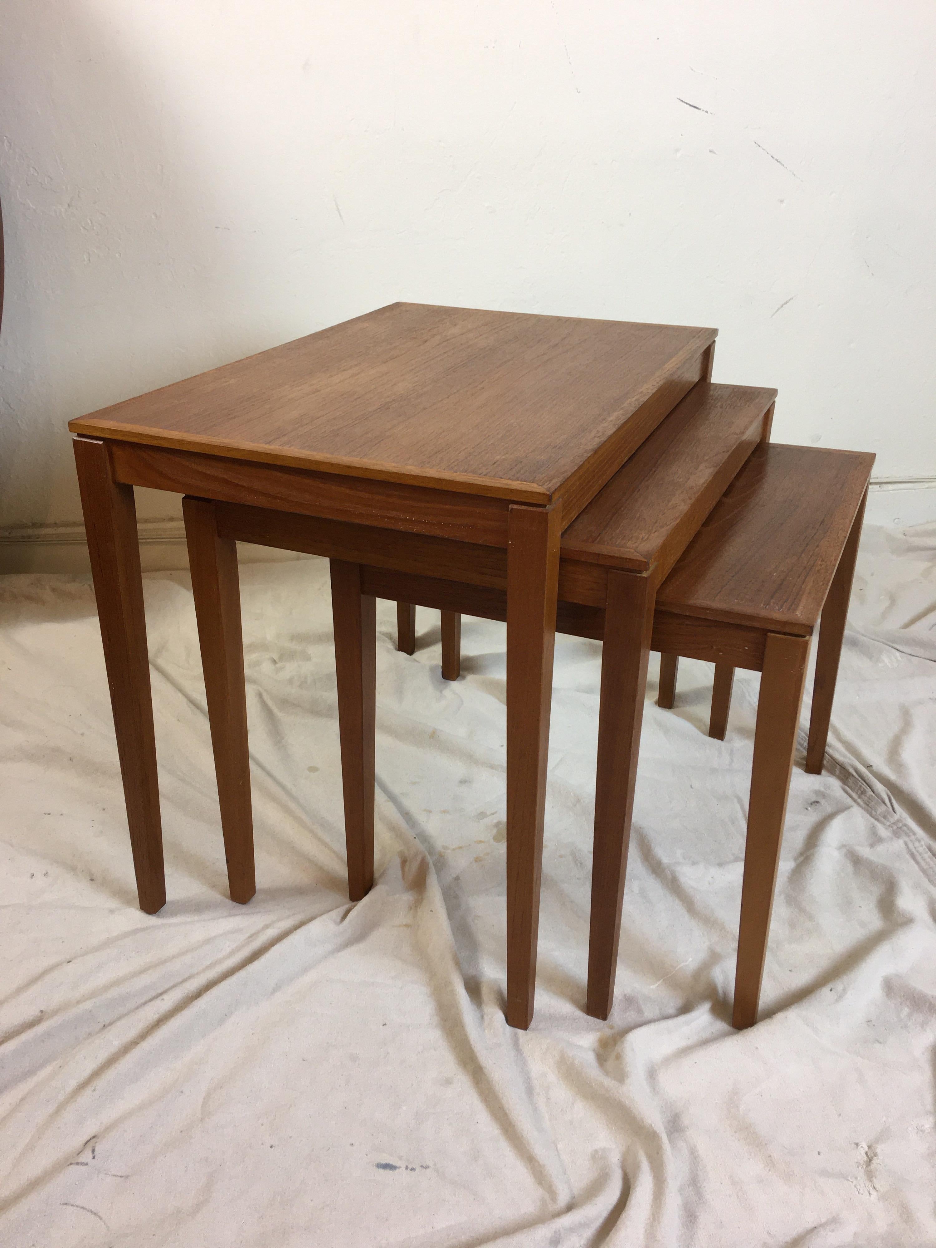 Set of 3 Bent Silberg's Mobler teak nesting tables. Nice grain and color. All three tables are the same depth 15.75 so they close up as basically one table. Very useful set! Largest table is 23.5 wide, middle table is 20.5 wide and small table is