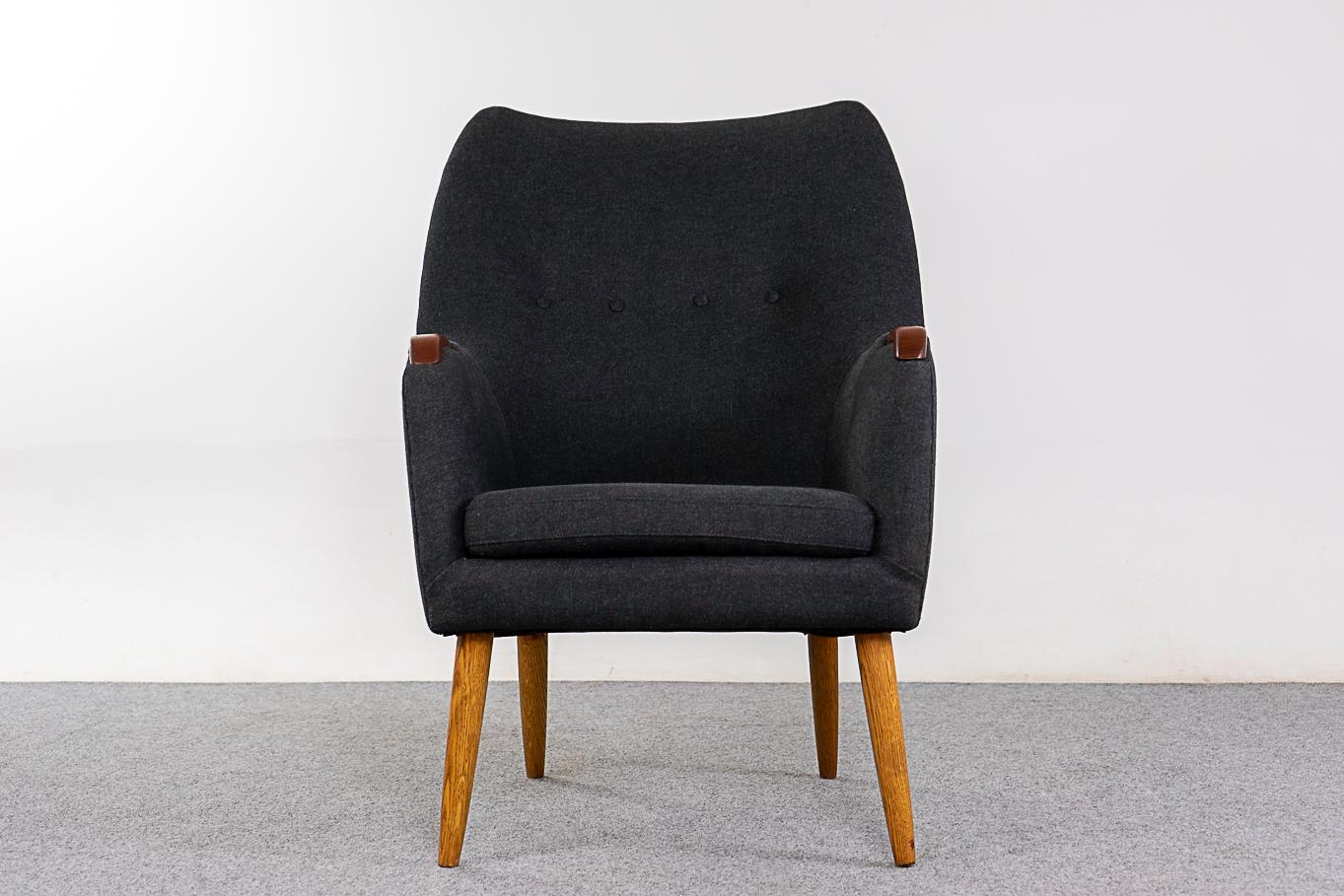 Teak & oak mid-century lounge chair, circa 1960's. Elegant, lovely silhouette with beautifully contrasting solid wood details. New charcoal grey upholstery in a blend of 70% pure new wool and 30% flax. Very comfortable!