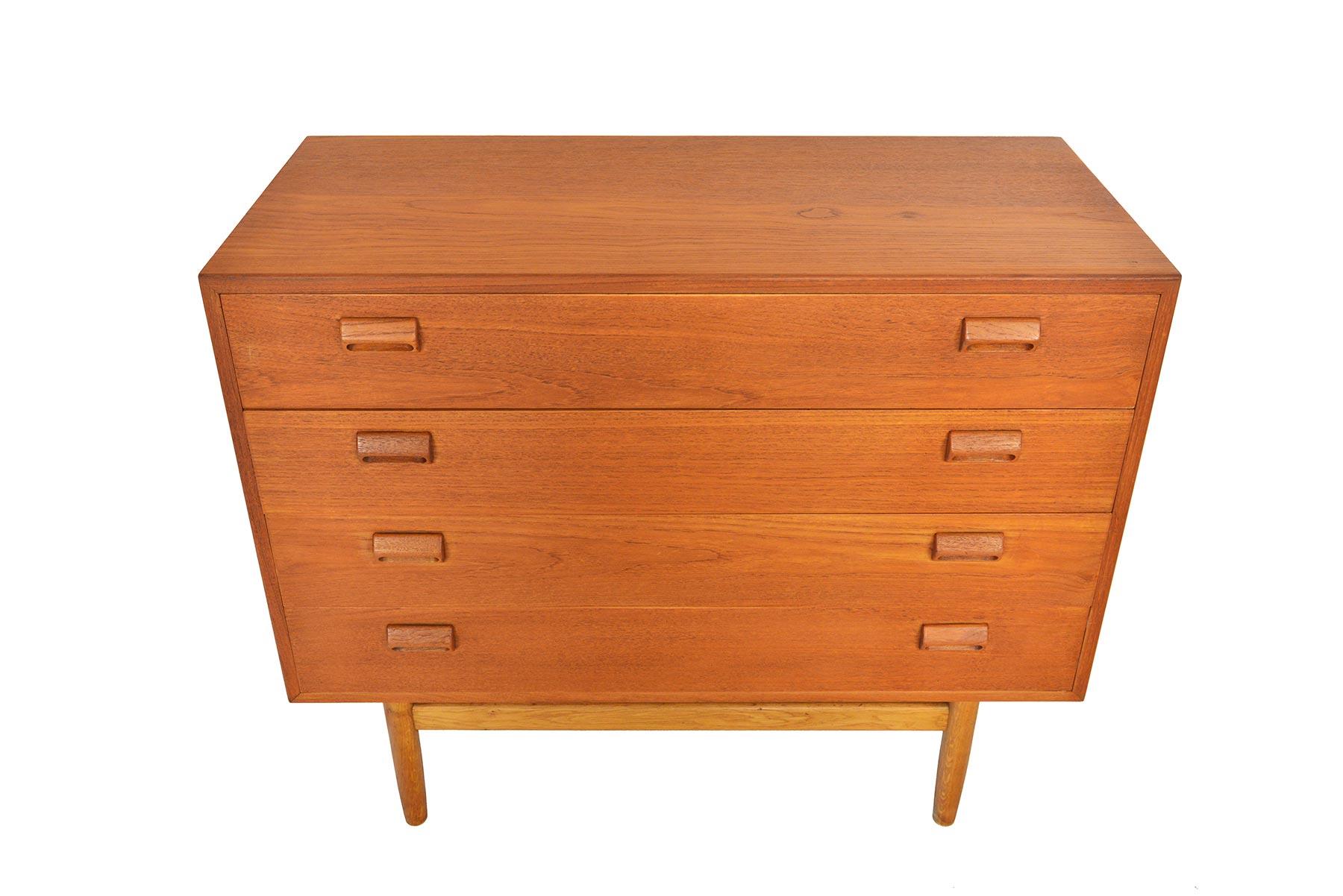 This beautiful gentleman's chest was designed by Børge Mogensen for Søborg Møbelfabrik in 1951. The case is expertly crafted in teak and stands on a solid oak base. Each drawer front is adorned with the designer's signature handles. Four deep