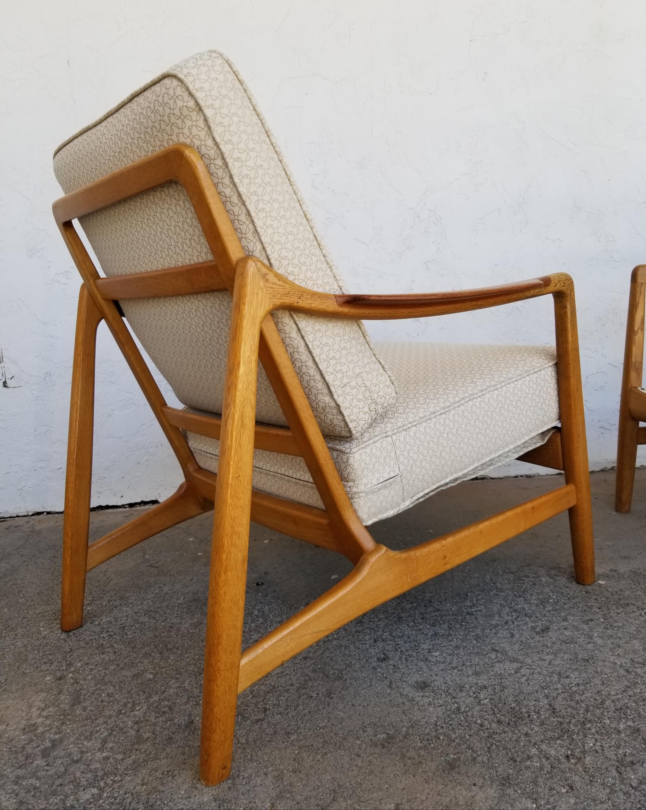 A fine pair of Danish modern lounge chairs made of teak & oak. Designed by Tove & Edvard Kindt-Larsen for France & Daverkosen. Denmark, Circa. 1960. Beautiful original finish with depth and glow to patina. Older re-upholstery is in excellent