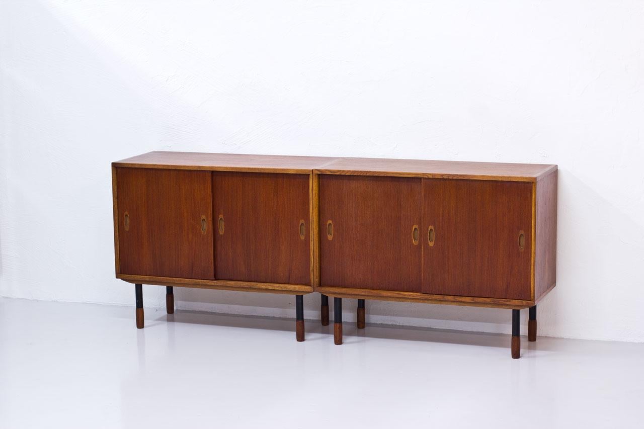 Pair of sideboards manufactured by Westbergs Möblers, in Sweden during the 1950s. Made from teak and oak, featuring black lacquered legs with teak feet. 
Drawers and shelves inside.