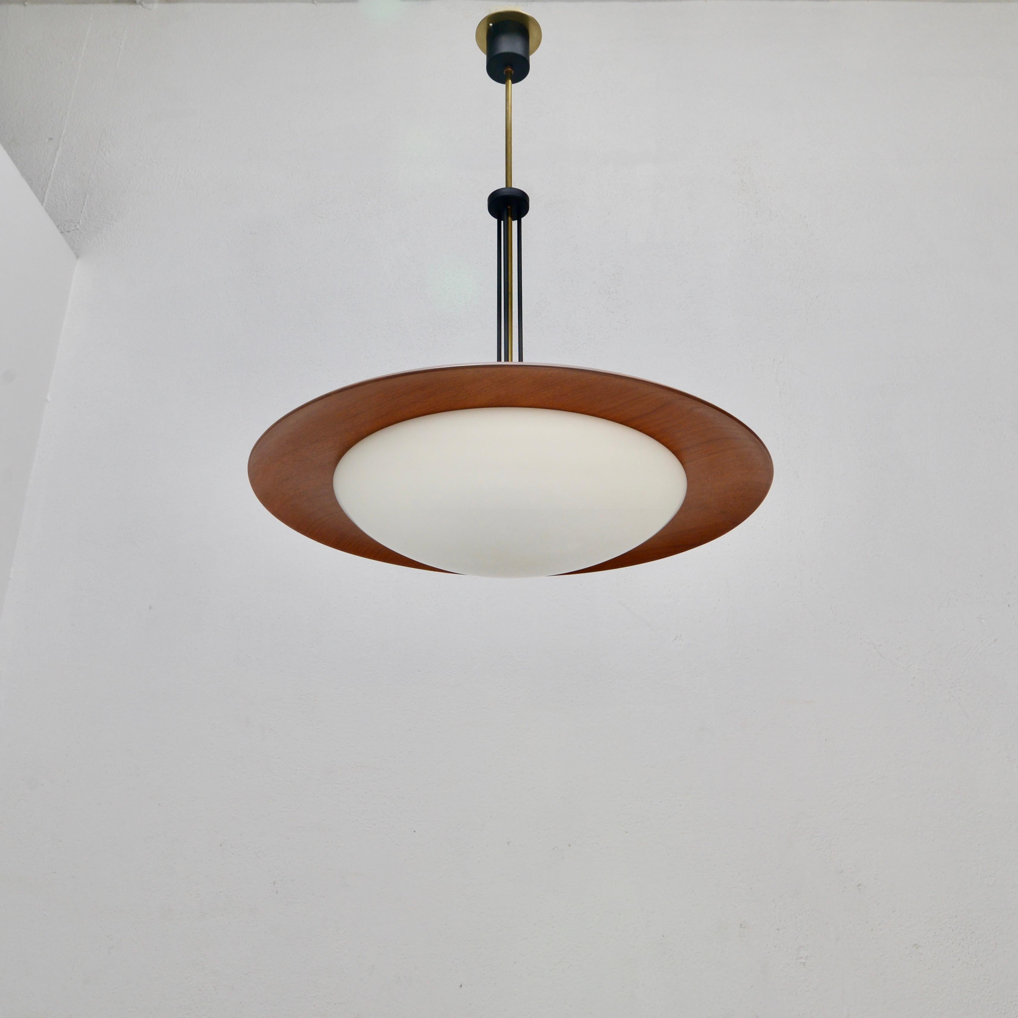 Classic midcentury Italian teak Omni pendant from the 1950s in brass, wood, glass and steel. Wired with a single E26 medium based socket and wired for use in the US. Light bulb included with order.
Measurements:
OAD: 34” 
Diameter: 24”
Fixture