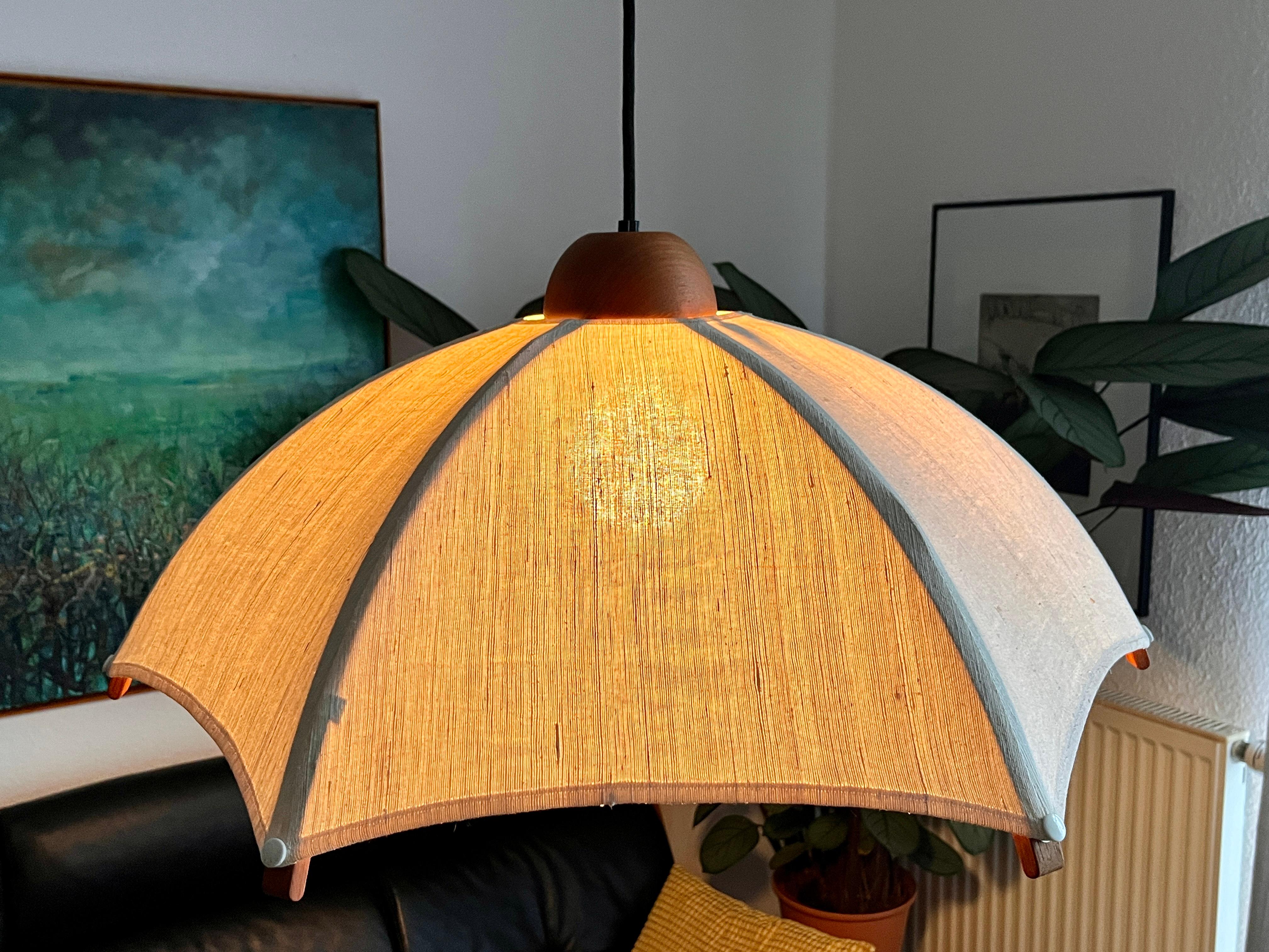 Gran lámpara colgante extensible de teca, de Domus, años 60.
La longitud de la lámpara se puede ajustar mediante el mecanismo de tracción. El mecanismo de tracción (peso del péndulo) funciona, y la longitud de la cuerda se puede ajustar tirando de