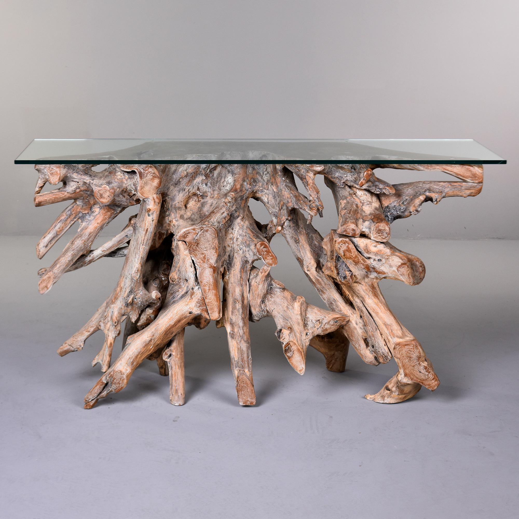 Console table with a base of a natural form mature teak wood root cluster. We believe the teak root was sourced in Asia. The teak roots have been lightened, planed, and sanded smooth by a US craftsman. The roots have been cut so that the base sits