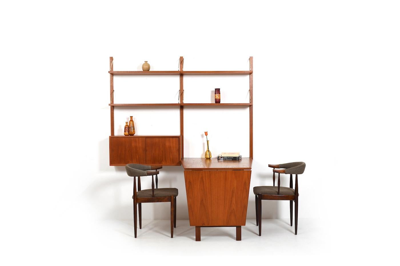 Royal system by Poul Cadovius for Cado Denmark. With 1 small cabinet, shelfes and conical shaped desk. brass holders. Part of the table top can be folded up. 1960s production.