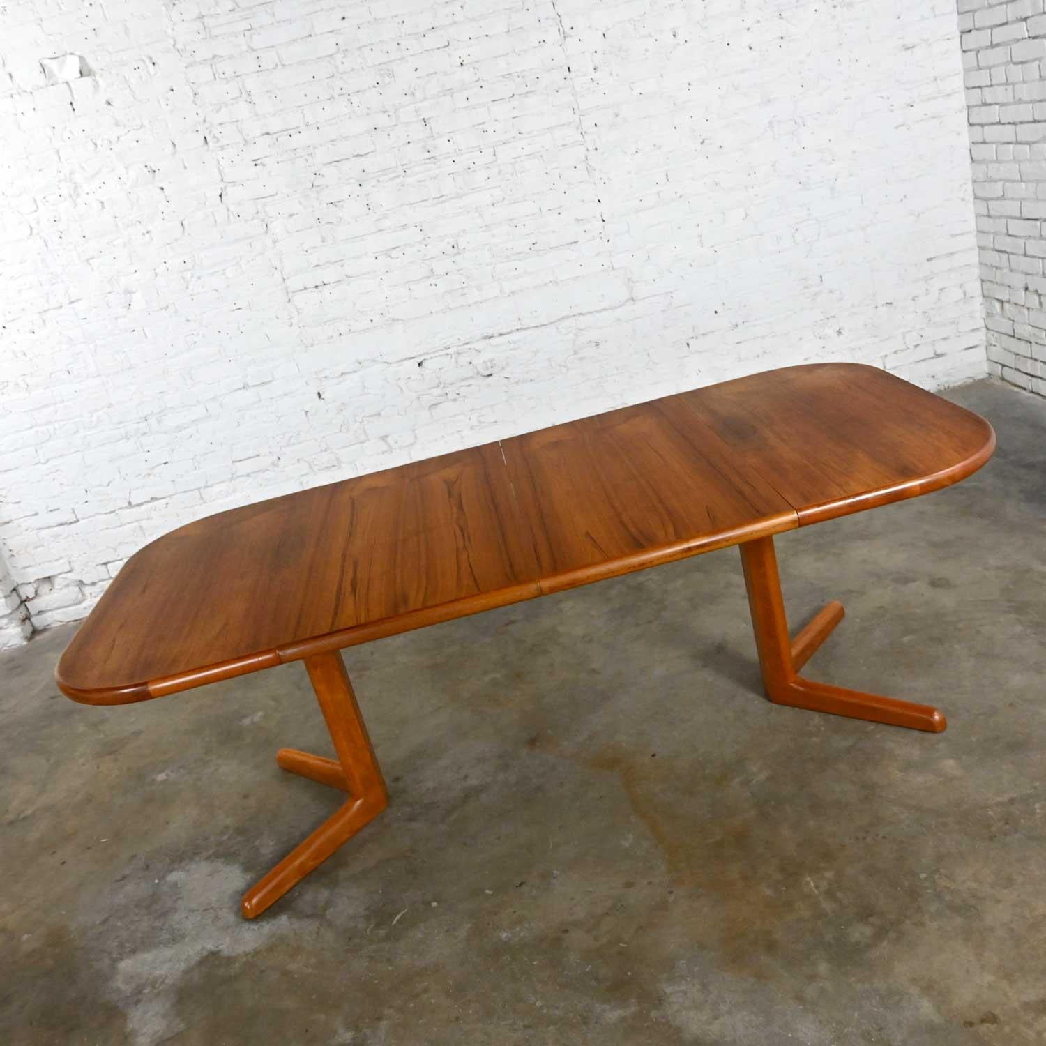 Gorgeous vintage teak Scandinavian Modern expanding dining table with 2 leaves. Unmarked but style of Neils Moller for Gudme Mobelfabrik. Beautiful condition, keeping in mind that this is vintage and not new so will have signs of use and wear. The
