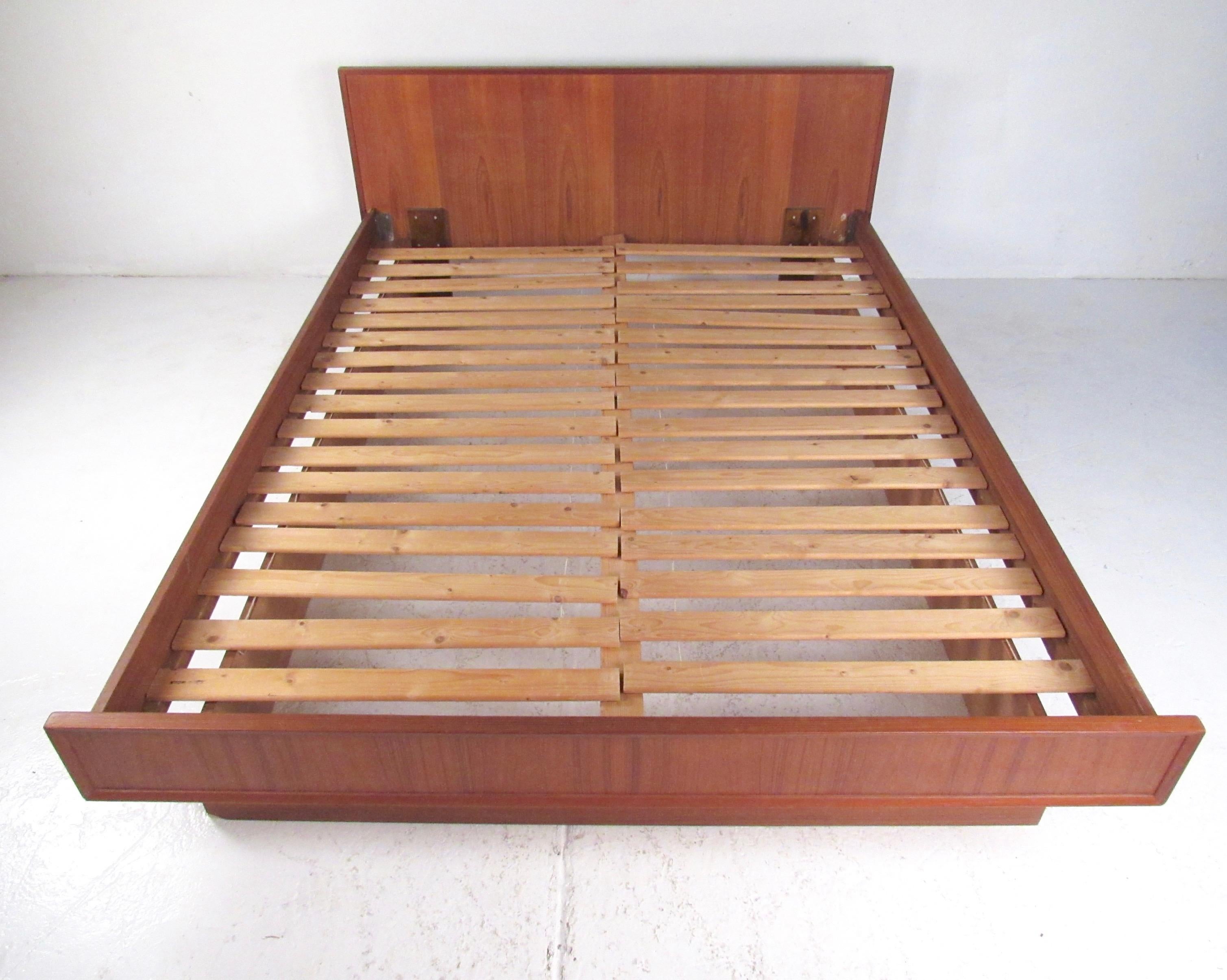 This striking Mid-Century Modern teak headboard and bed frame makes a striking vintage modern addition to your bedroom setting. Perfect fit for a queen-size mattress, the natural tone of the teak adds Scandinavian Modern flair to any interior.