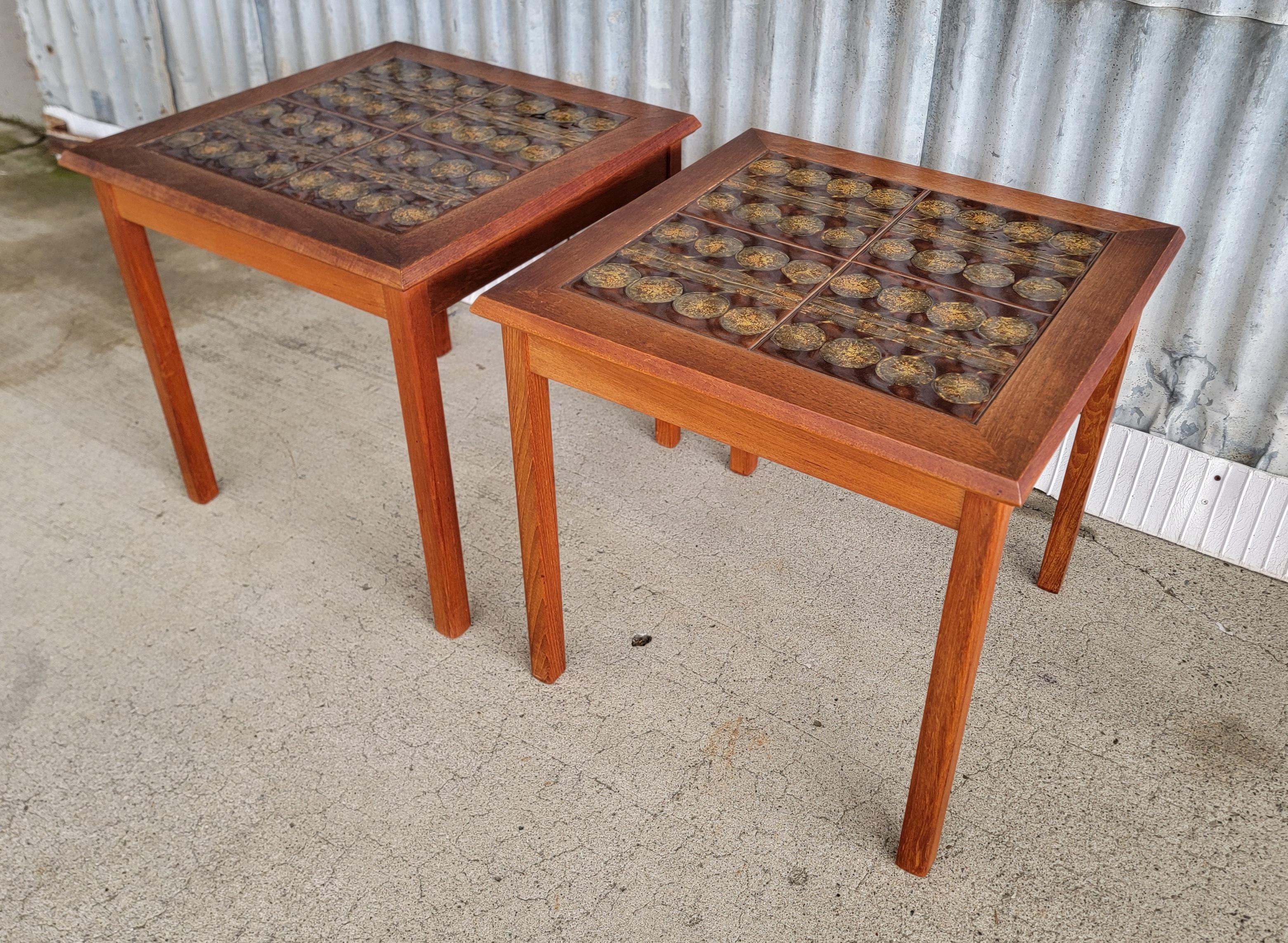 Nice pair of Danish Modern teak and ceramic tile top side or end tables. Each table has 4 abstract gold and brown tiles. Made by Mobelfabrikken Toften, Norway, 1970's. Very good, original condition.