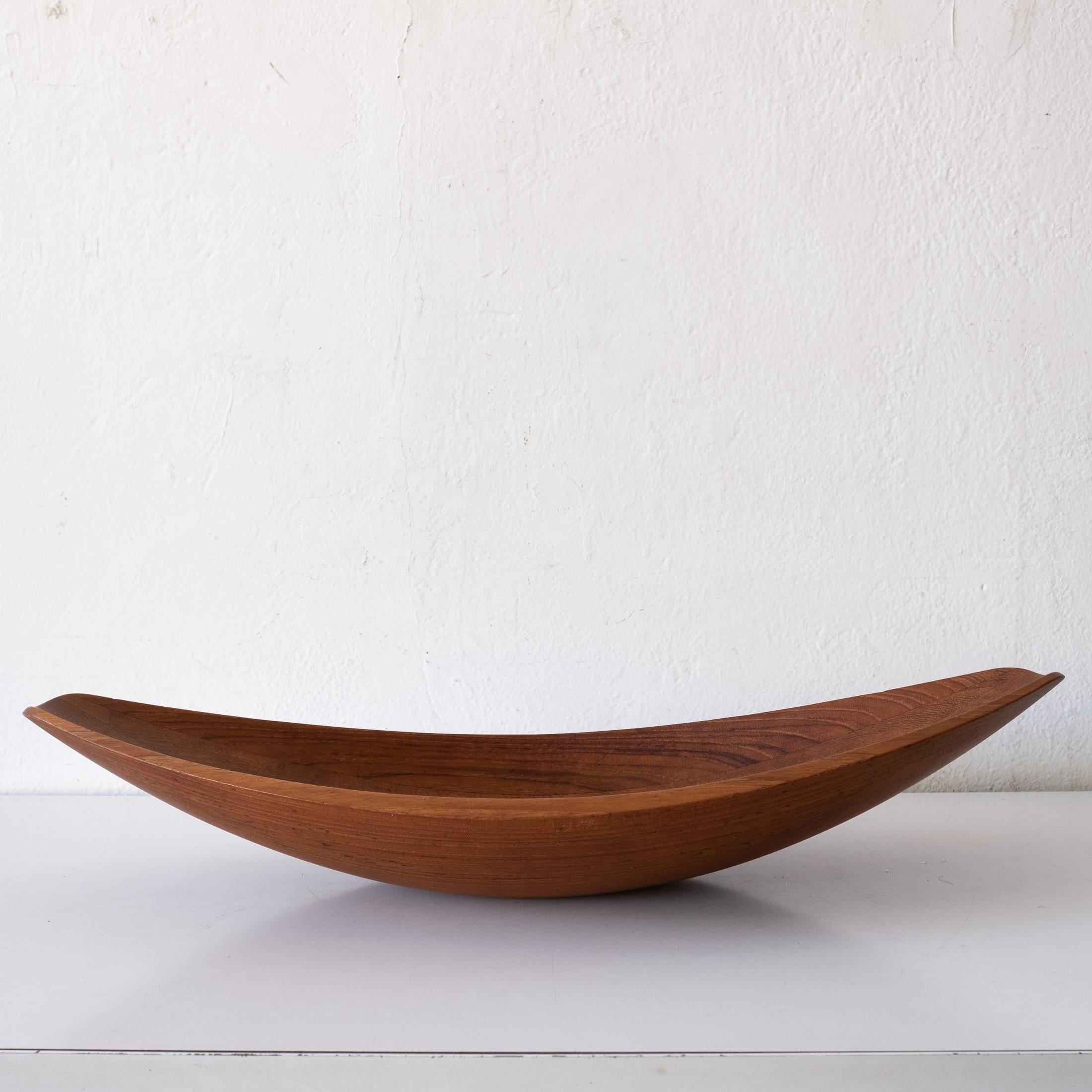 Canoe fruit or salad bowl by Jens Quistgaard for Dansk. Staved teak with early Dansk mark, Denmark, 1950s.

Jens Harald Quistgaard (1919-2008) was a Danish sculptor and designer, known principally for his work for Dansk Designs, where he was the