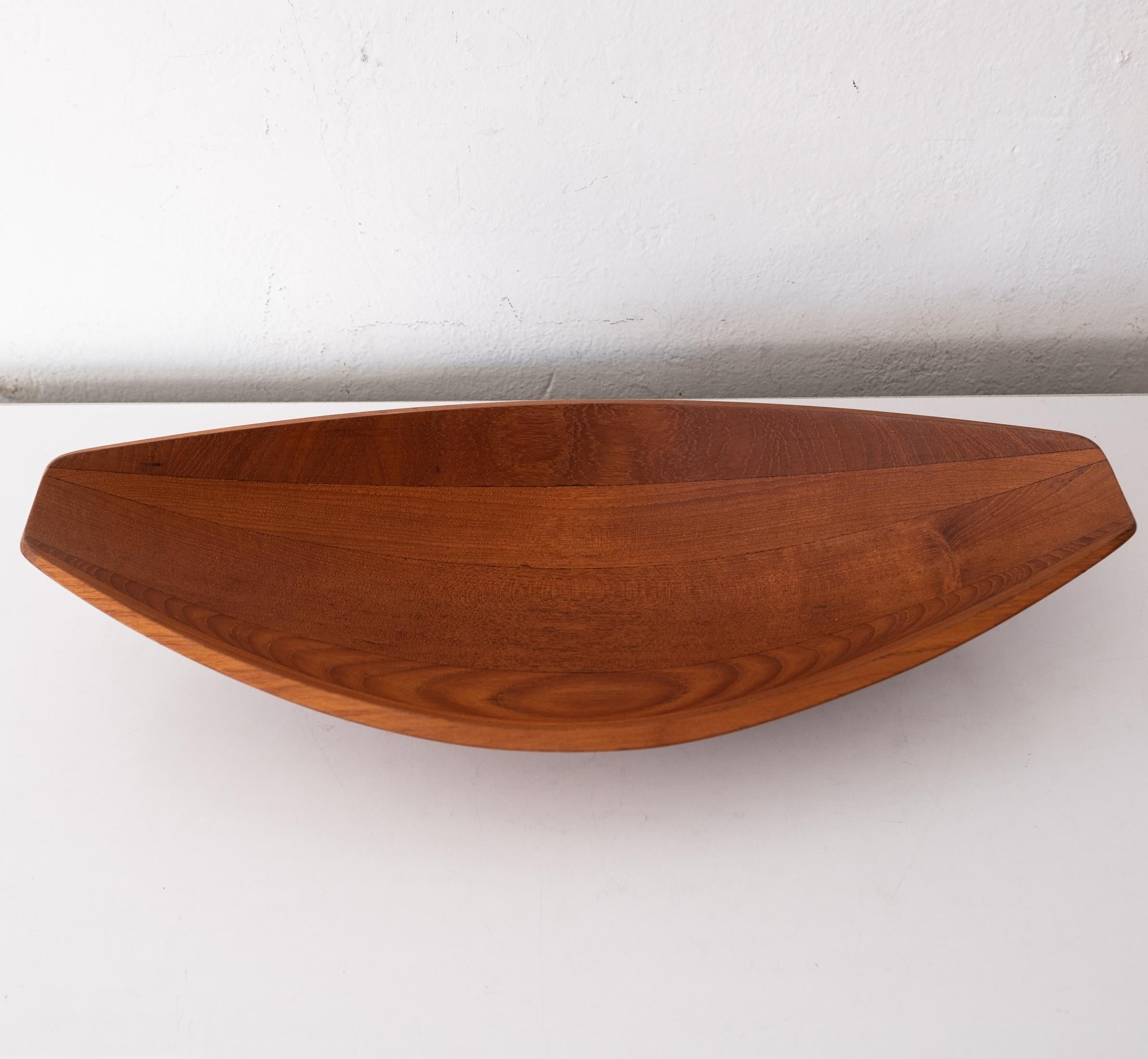 Canoe fruit or salad bowl by Jens Quistgaard for Dansk. Staved teak with early Dansk mark, Denmark, 1950s.

Jens Harald Quistgaard (1919-2008) was a Danish sculptor and designer, known principally for his work for Dansk Designs, where he was the