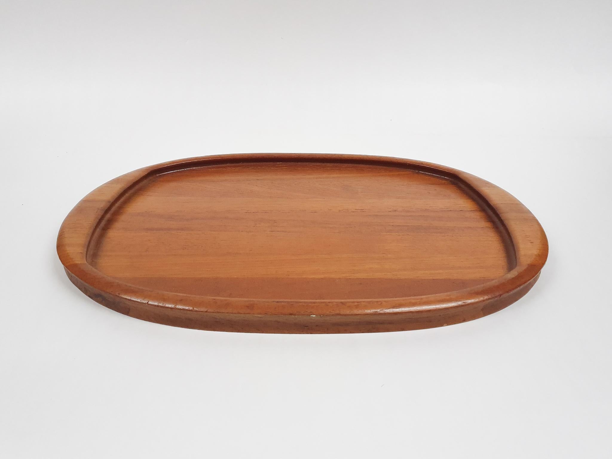 Solid teak serving tray. Marked at the bottom.

 