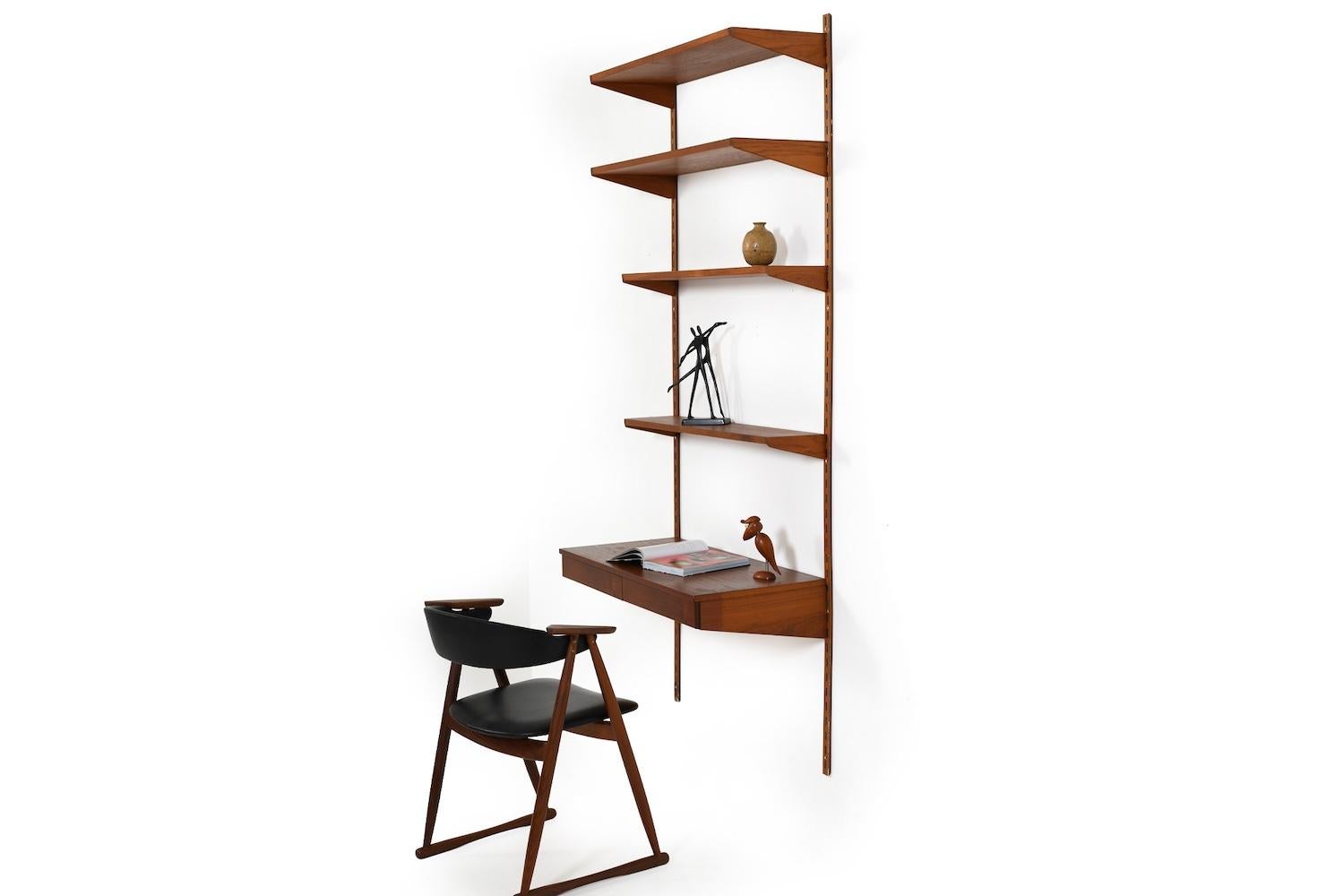 Kai Kristiansen wall system in teak. Manufactured by FM Feldballes Møbelfabrik Denmark in 1960s. Chair is not incl.
The wall unit consists of:
- 4 shelves
- 1 desk top with drawers
- 2 wall brackets

detailed measurements:
shelves: 2x  18.0 x 85.5