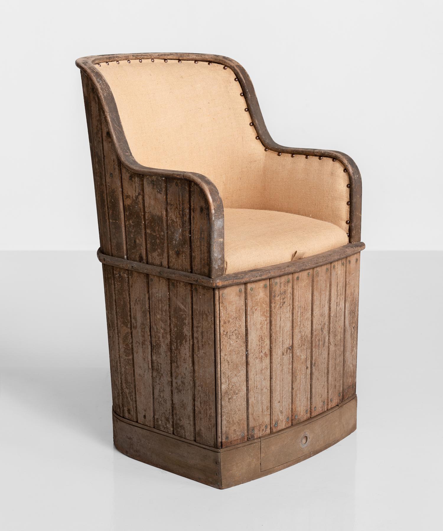 Teak ships armchair, England, circa 1880.

Slatted teak construction with brass screws, newly upholstered in linen. Seat lifts off to reveal a large storage area underneath.