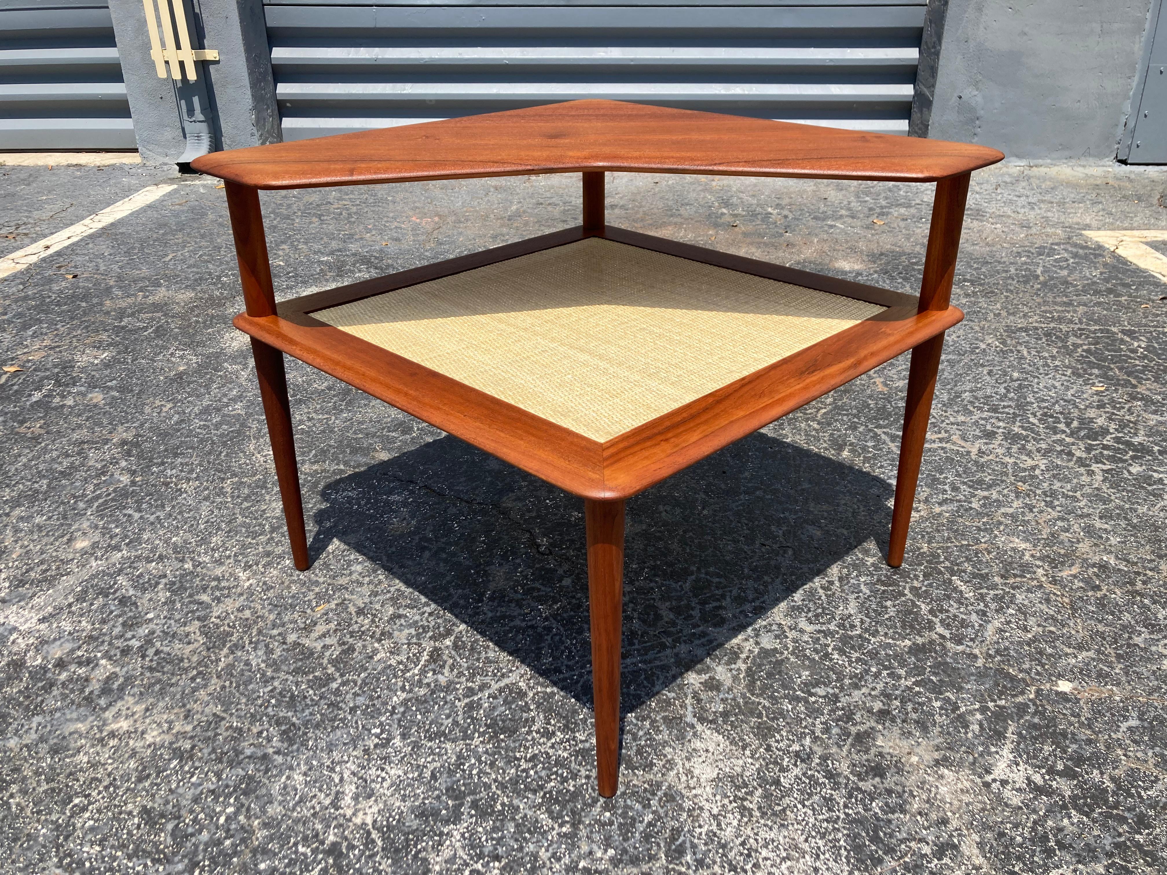 Beautiful side or corner table by Peter Hvidt & Orla Mølgaard-Nielsen for France & Son. Solid teak and cane, the table is marked. The height of the cane top is 16.75”.