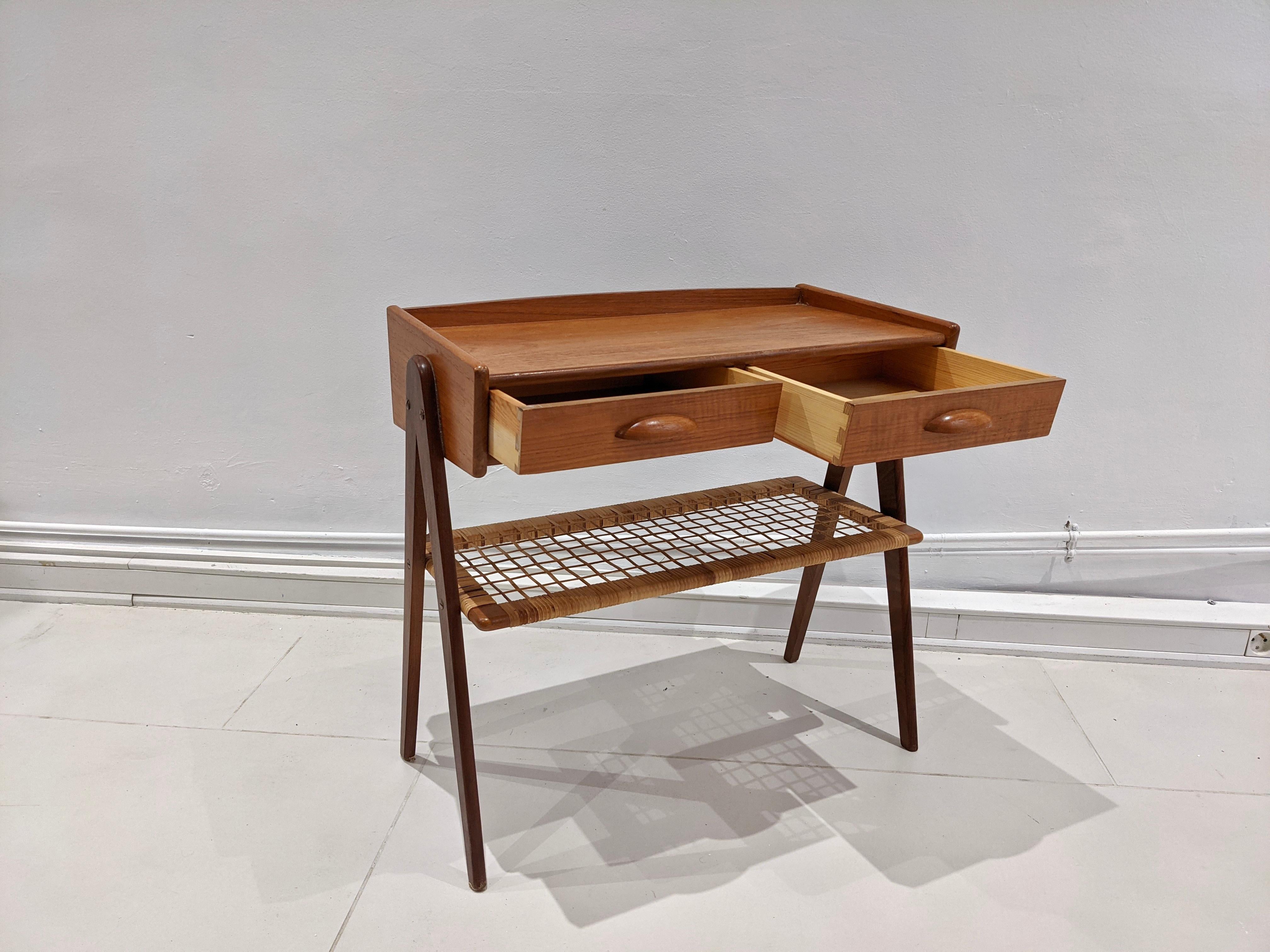 Teak side table designed by Danish designer Søren Rasmussen in the 1960s. The desk is teak and rattan. Very good condition.
 
