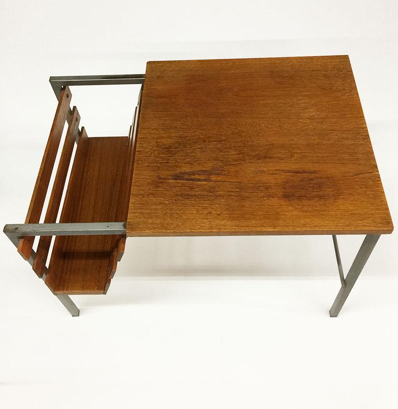 Teak side table with magazine rack

A side table and a magazine rack at the end of the table on a metal base with teak finish, 1970s
The measurement is 60 cm wide and 40 cm high
The depth is 40 cm




