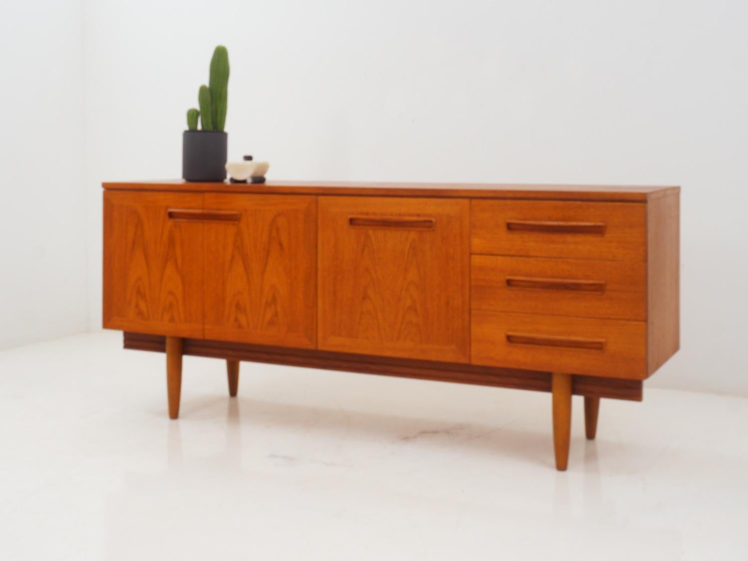 Discover the epitome of midcentury charm with a meticulously crafted teakwood credenza. It combines timeless beauty of clean lines, warm teak hues, and sleek design, while offering ample storage space. 

- 67