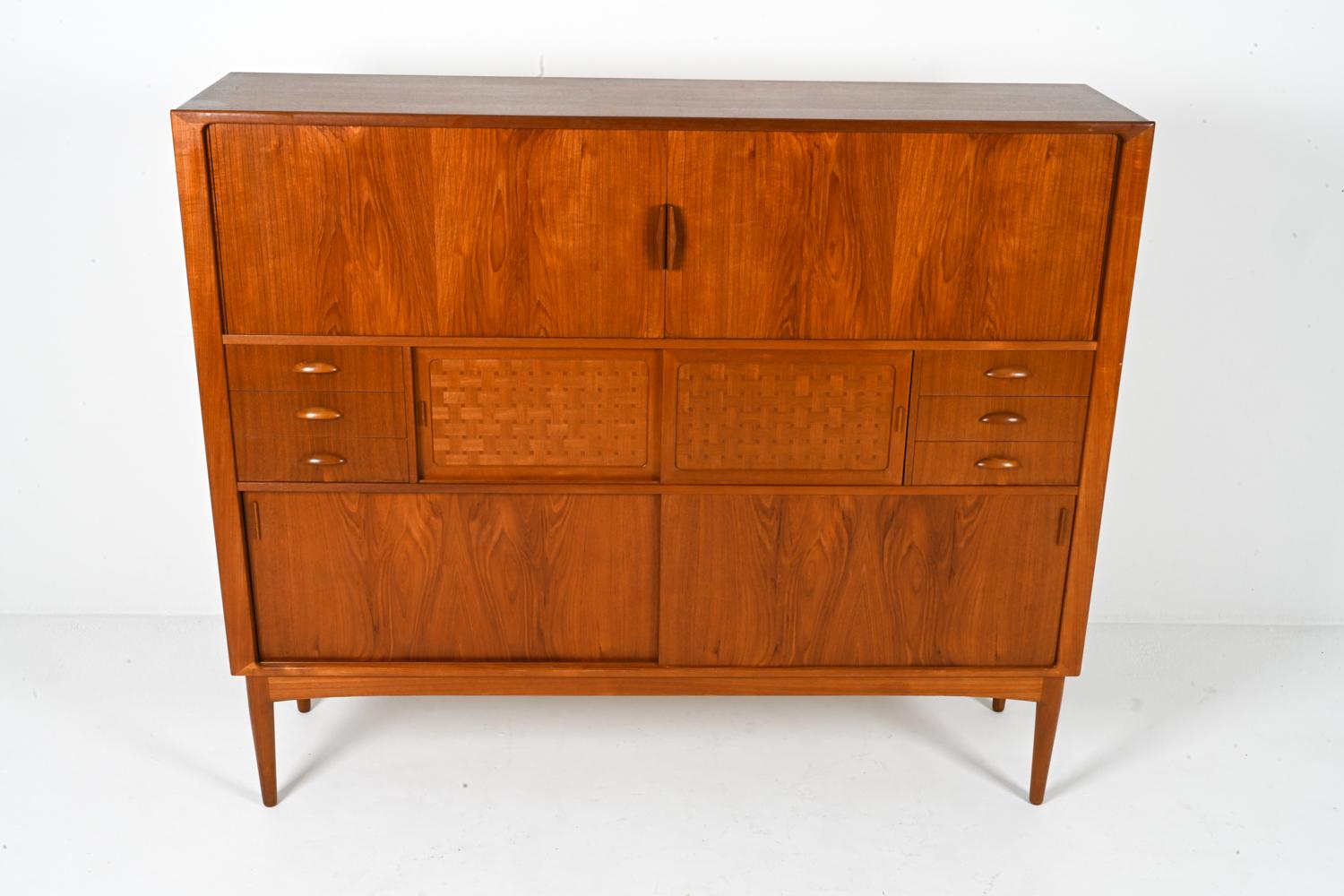 This exceptional sideboard embodies the pinnacle of Danish design, a masterpiece crafted by renowned furniture maker Johannes Andersen in the Mid-Century Modern era. Constructed from rich, teak wood, it showcases the exquisite form, exceptional