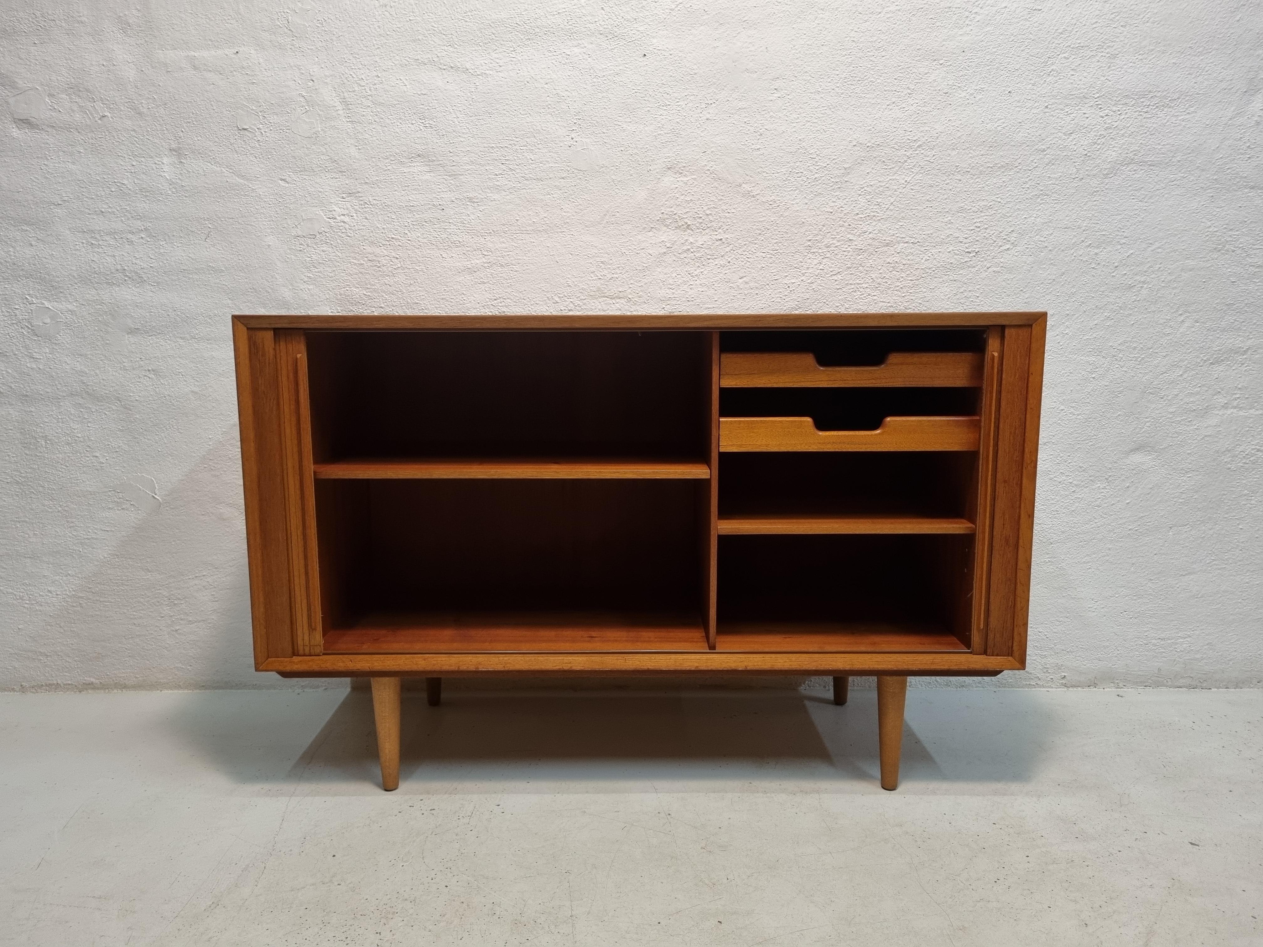 Teak sideboard with shutter doors. Manufactured at Ølholm Møbelfabrik.

Ølholm is the name of the town in Denmark where the furniture factory was located.

Ølholm had two furniture factories at the time, Ølholm Møbelfabrik owned by Sigfred Omann and