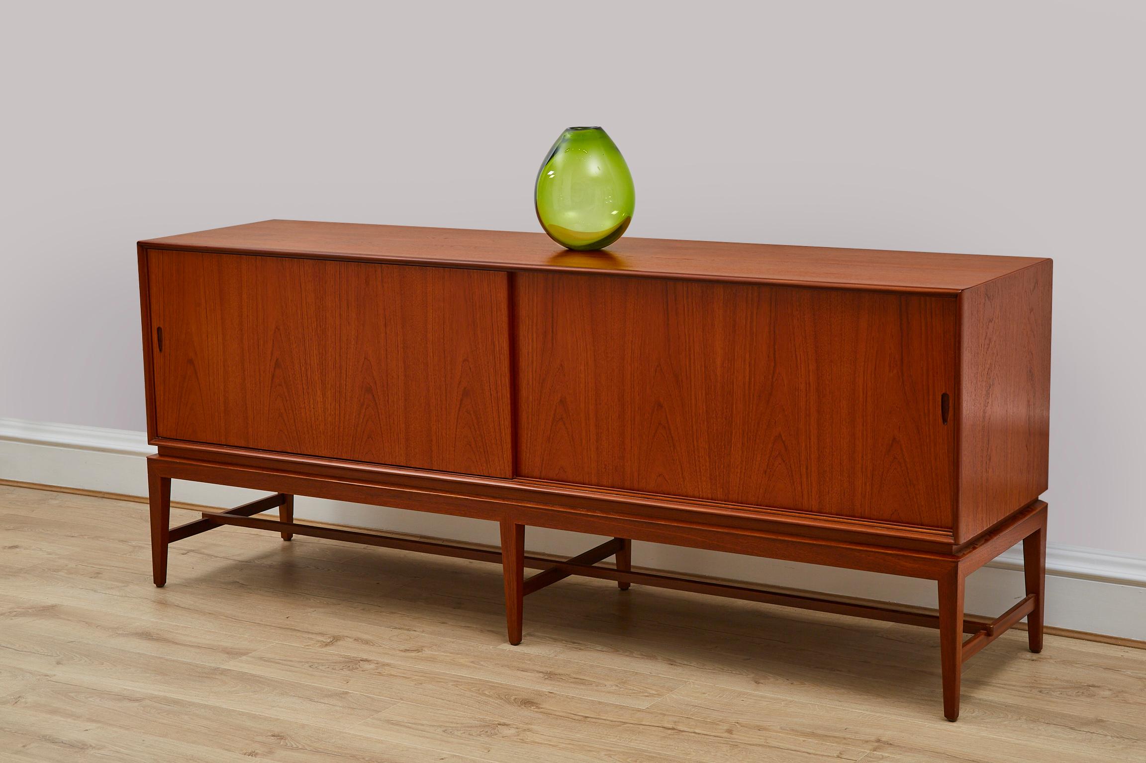 A sideboard designed by Severin Hansen. It was produced in the 1960s in Denmark. Covered with Teak veneer. The sideboard has a roomy interior, shelves, and drawers behind a sliding door.


Danish furniture designer Severin Hansen Jr. is best