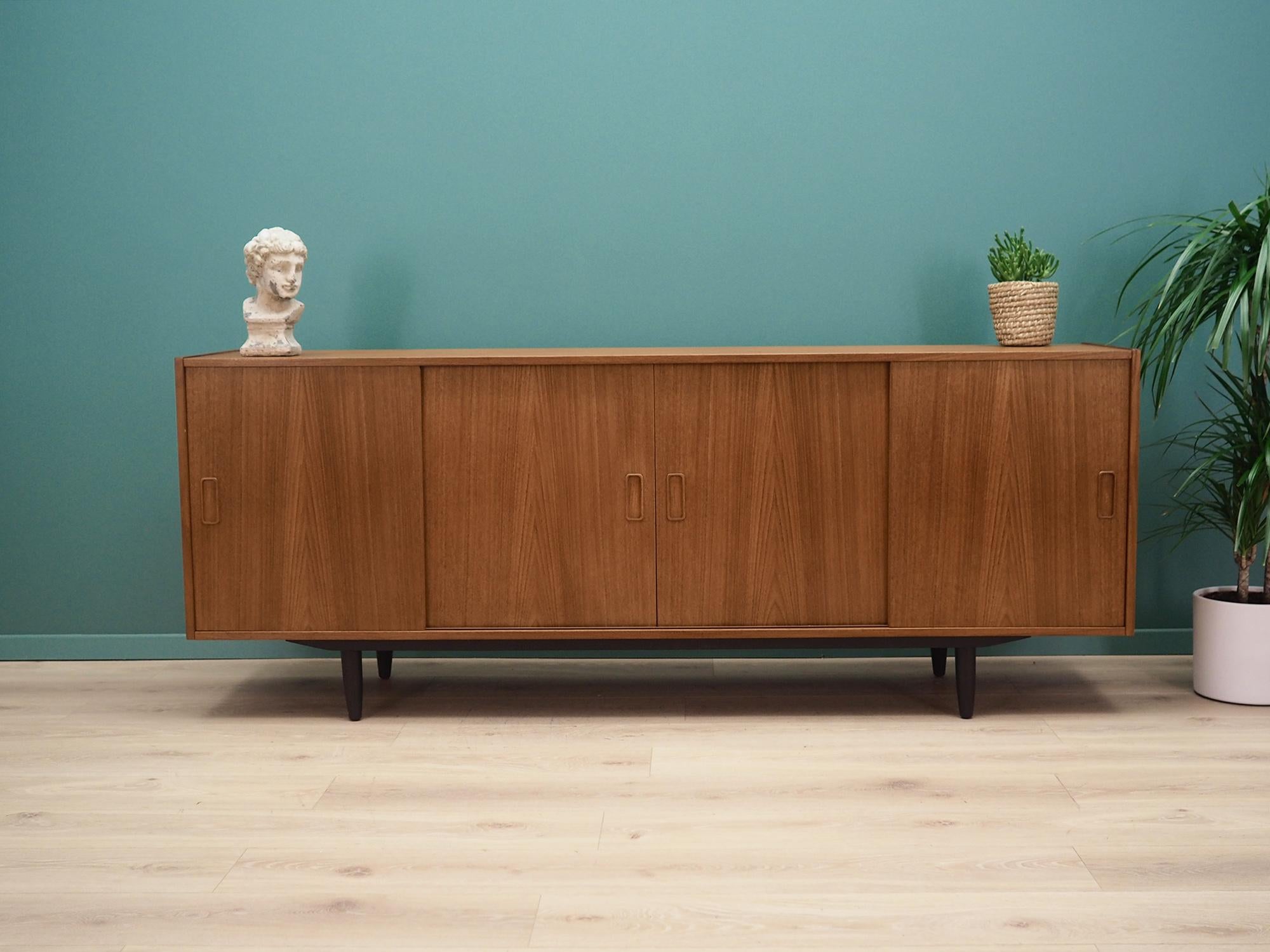 Sideboard was made in the 1960s and was produced by the famous Danish manufacturer Westergard. It was designed by the leading Danish design icon Erik Jensen.

The structure is covered with teak veneer. The legs are made of solid wood and