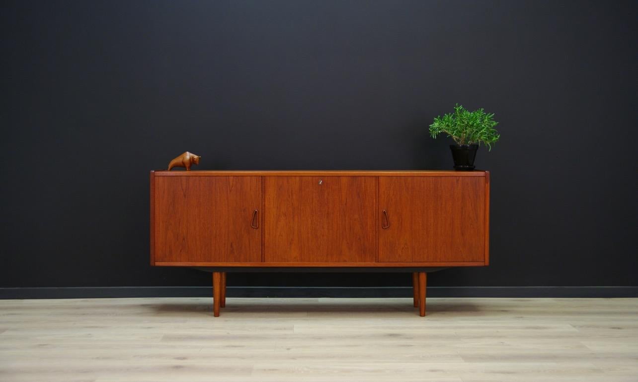 Classic sideboard from the 1960s-1970s, Danish design. Furniture veneered with teak. Behind the sliding doors - the shelf and in the central section the decorative mirror. The key in the set. Preserved in good condition (small bruises and scratches)