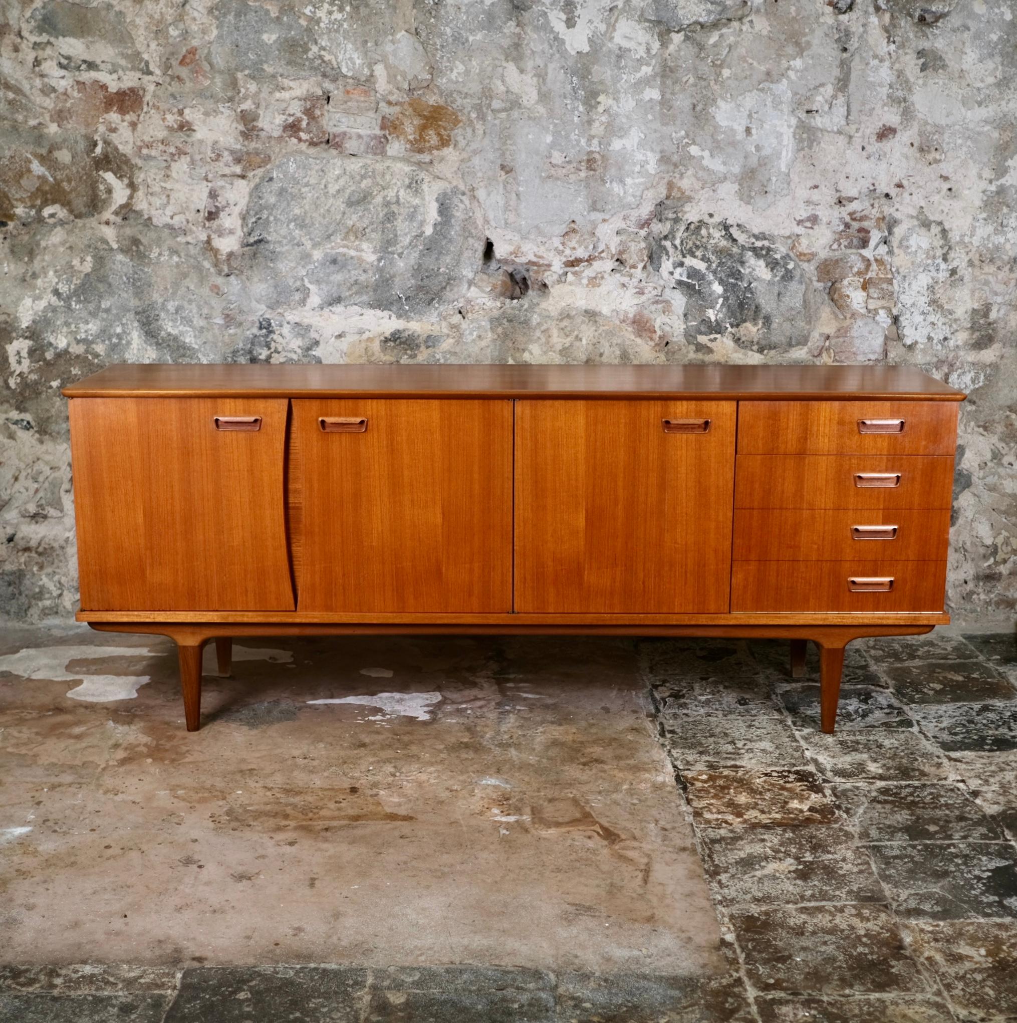 Beautiful teak sideboard made in France in 1966, by LB edition, after a design by Ib Kofod Larsen.
Scandinavian style, with nice making and joining details.
Very good condition, rare traces of time.
Label of the editor.
Dimensions : W224, H90, D50cm