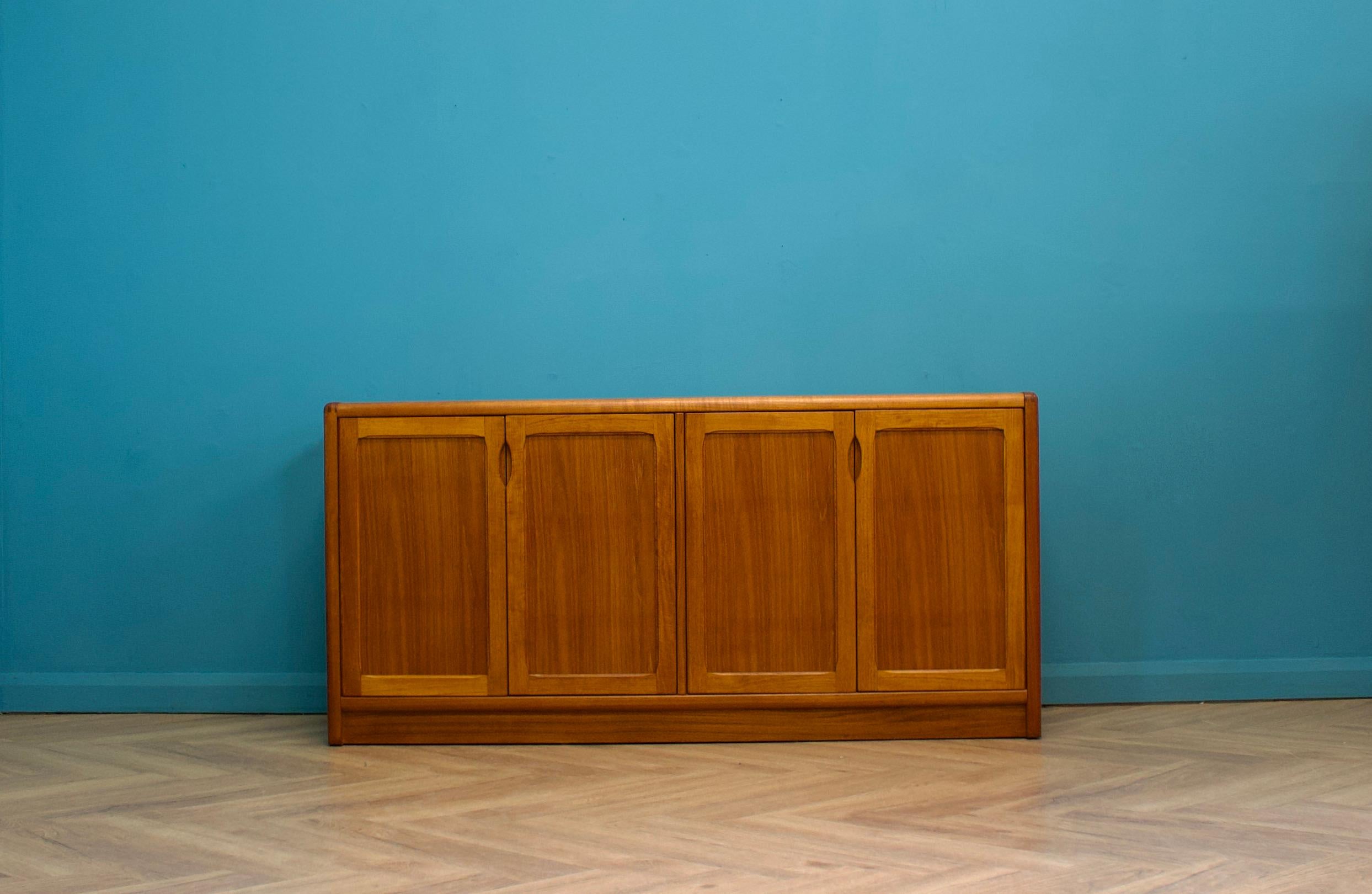A mid century quality made Danish teak sideboard from D Scan, circa 1970s (the company outsourced their production to Singapore during the mid 70s)

A sleek minimalist design - featuring three cupboard doors, both with shelving and drawers
