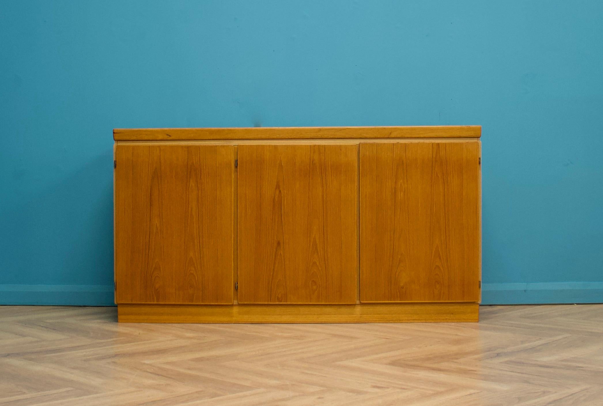 A mid century Danish teak sideboard from Skovby, circa 1970s

A sleek minimalist design - featuring three cupboard doors,  one with shelving or drawers