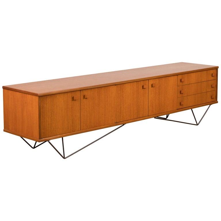 Midcentury teak sideboard from the 1960s. It is a shining example of the form and function synonymous with Danish furniture of this era. It has is all; well-built, great design and heaviness. Three large drawers and four doors hiding storage space.