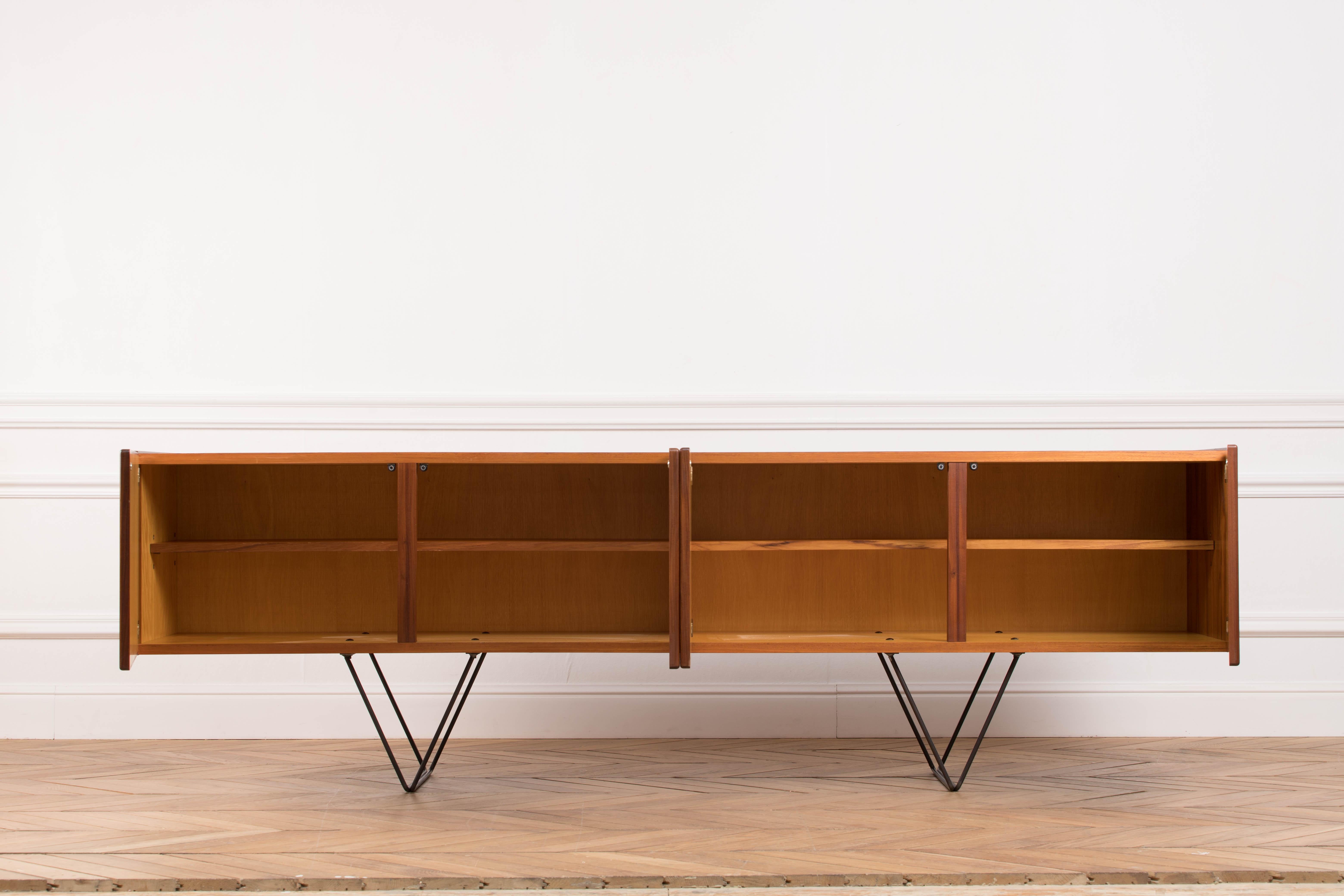 Mid-Century teak sideboard from the 1960s. It is a shining example of the form and function synonymous with Danish furniture of this era. It has is all; well-built, great design and heaviness. Three large drawers and four doors hiding storage space.