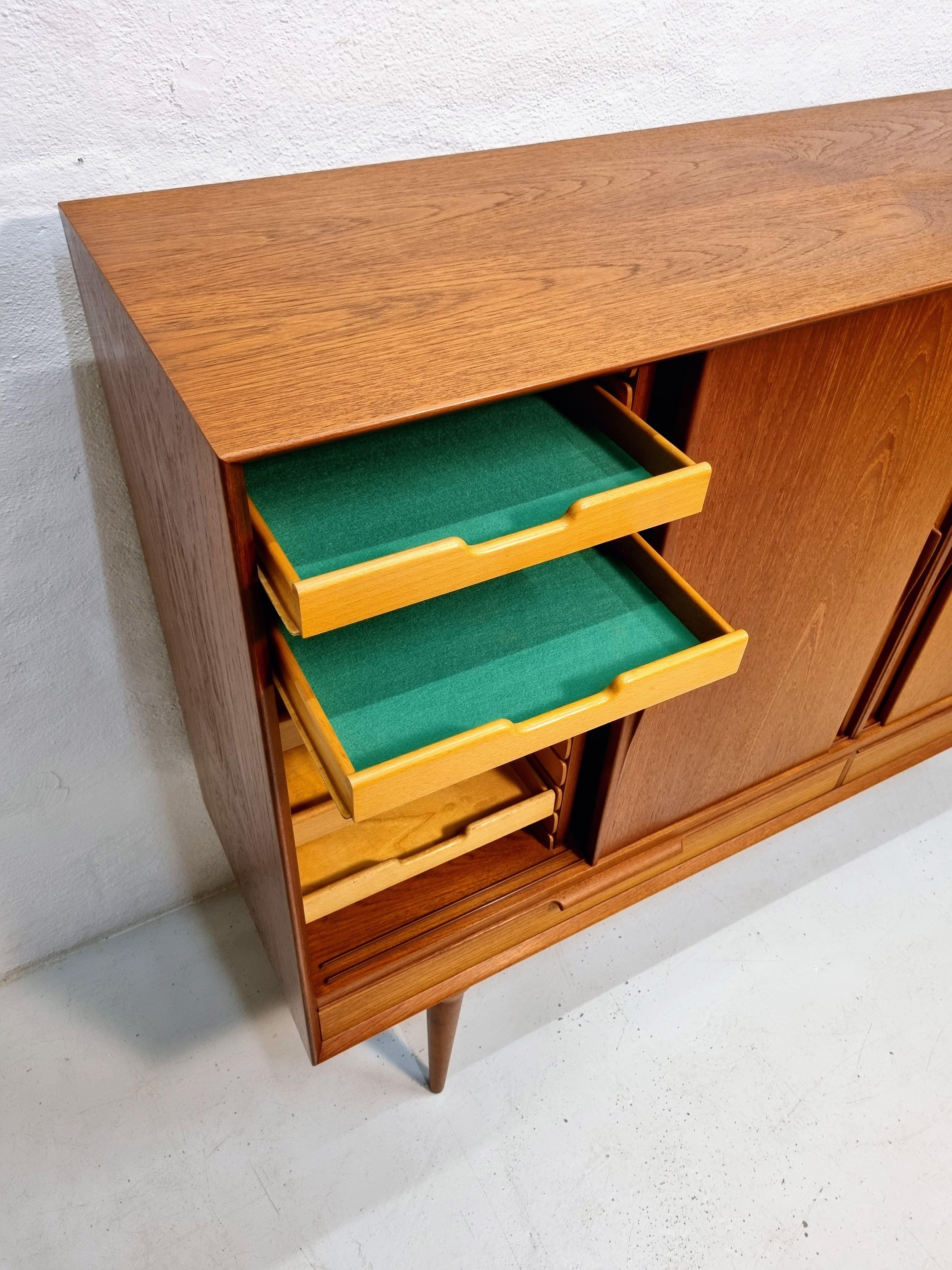 Highboard made of teak, Model no 13 by Gunni Omann for Omann Junior furniture factory.  
Made of quality materials with nice details such as the nice triangular handles.  
The sideboard consists of 2 drawers at the bottom and above there are 4