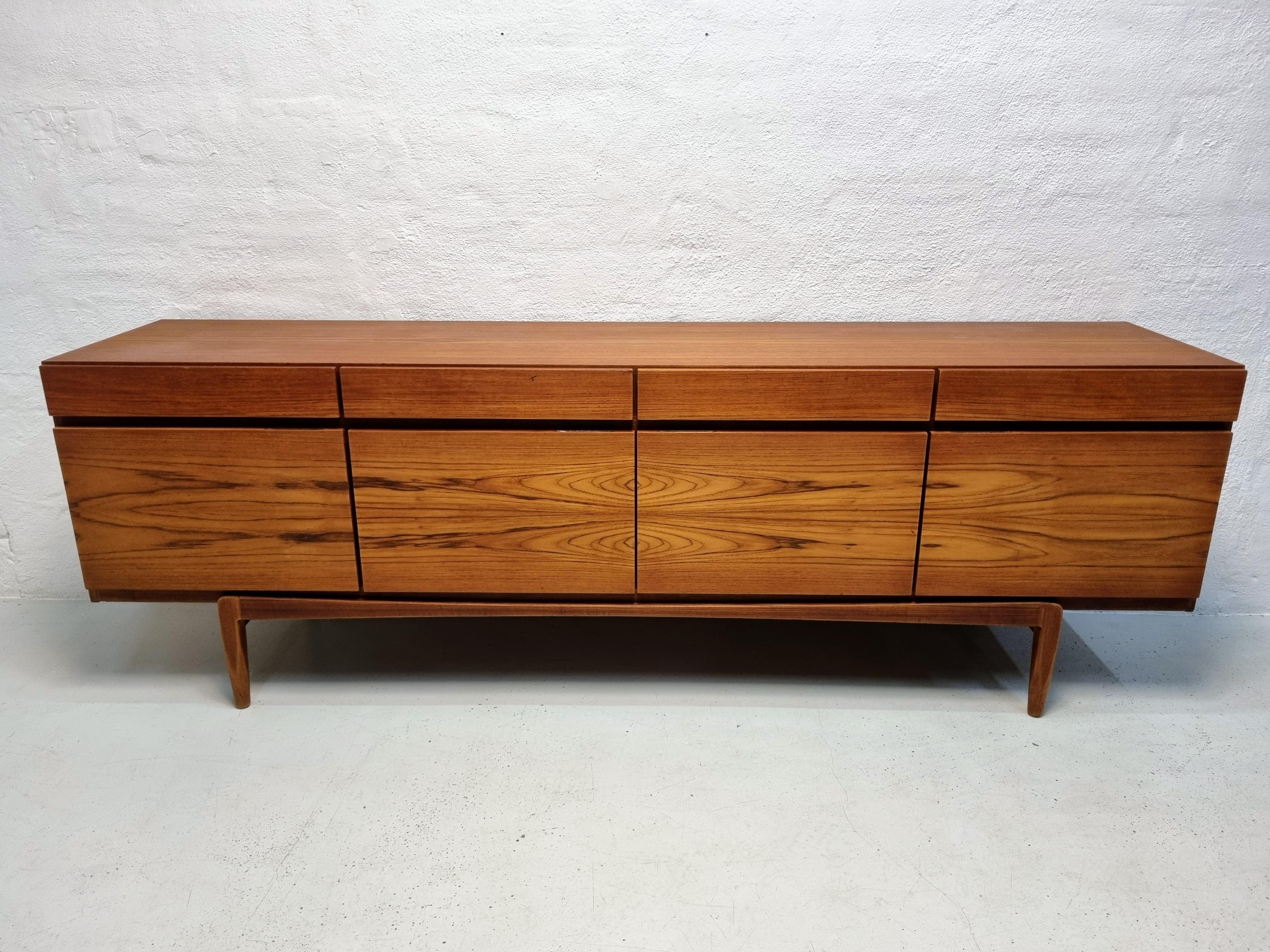 The sideboard Model FA-66 was designed by Ib Kofod Larsen in 1966 for Faarup Møbelfabrik, it is one of the popular designs and it is easy to see why.

This sideboard is made of teak, there are 4 drawers at the top and 4 doors at the bottom, behind