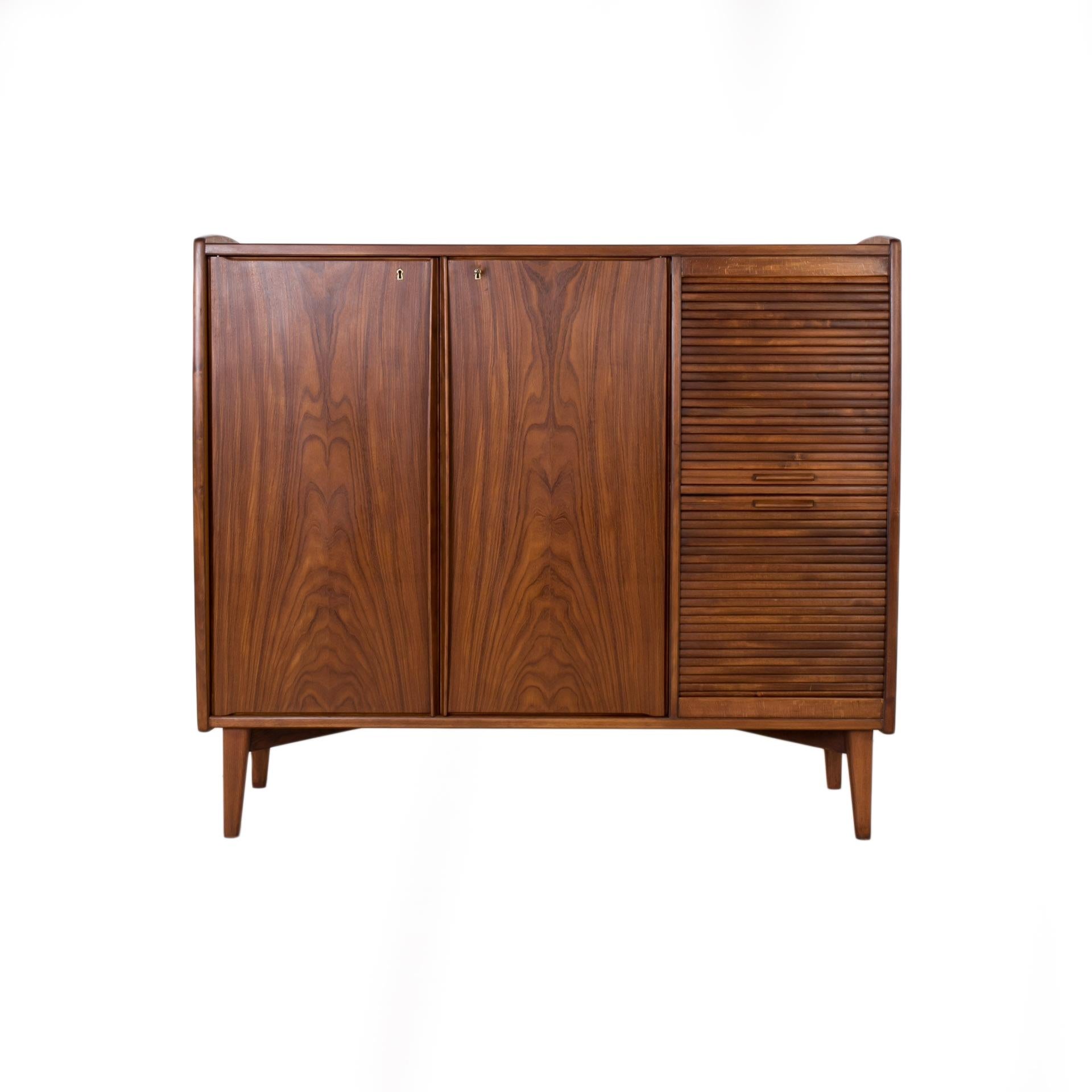 Rare Teak Sideboard or Bar Cabinet by Alfred Sand, Norway, 1960s

This absolutely rare sideboard was designed by Alfred Sand for MOBELFABRIKK FLEKKEFJORD around 1960s and still has the original label on the back side of the door. The piece is