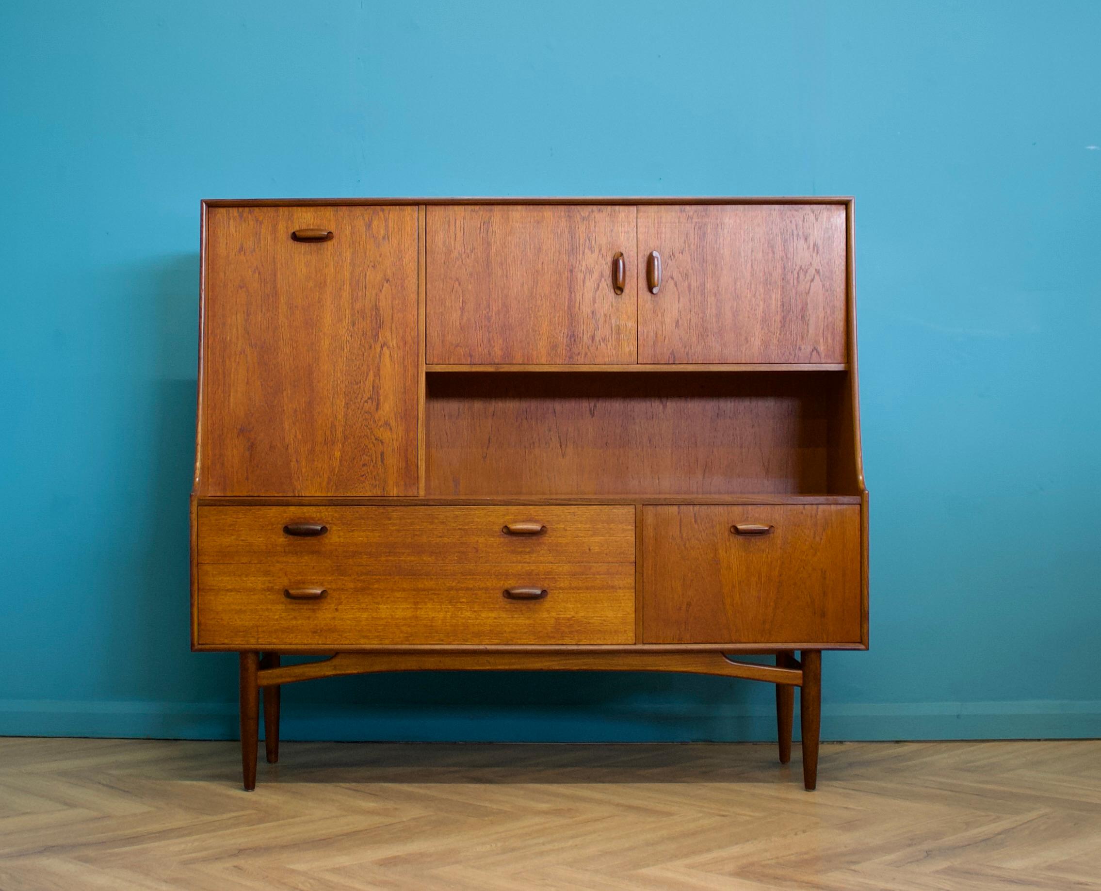 A compact size teak drinks cabinet or highboard from G Plan - Circa 1960s

It features a two cupboards, a pull down drinks compartment, two drawers and removable shelves

