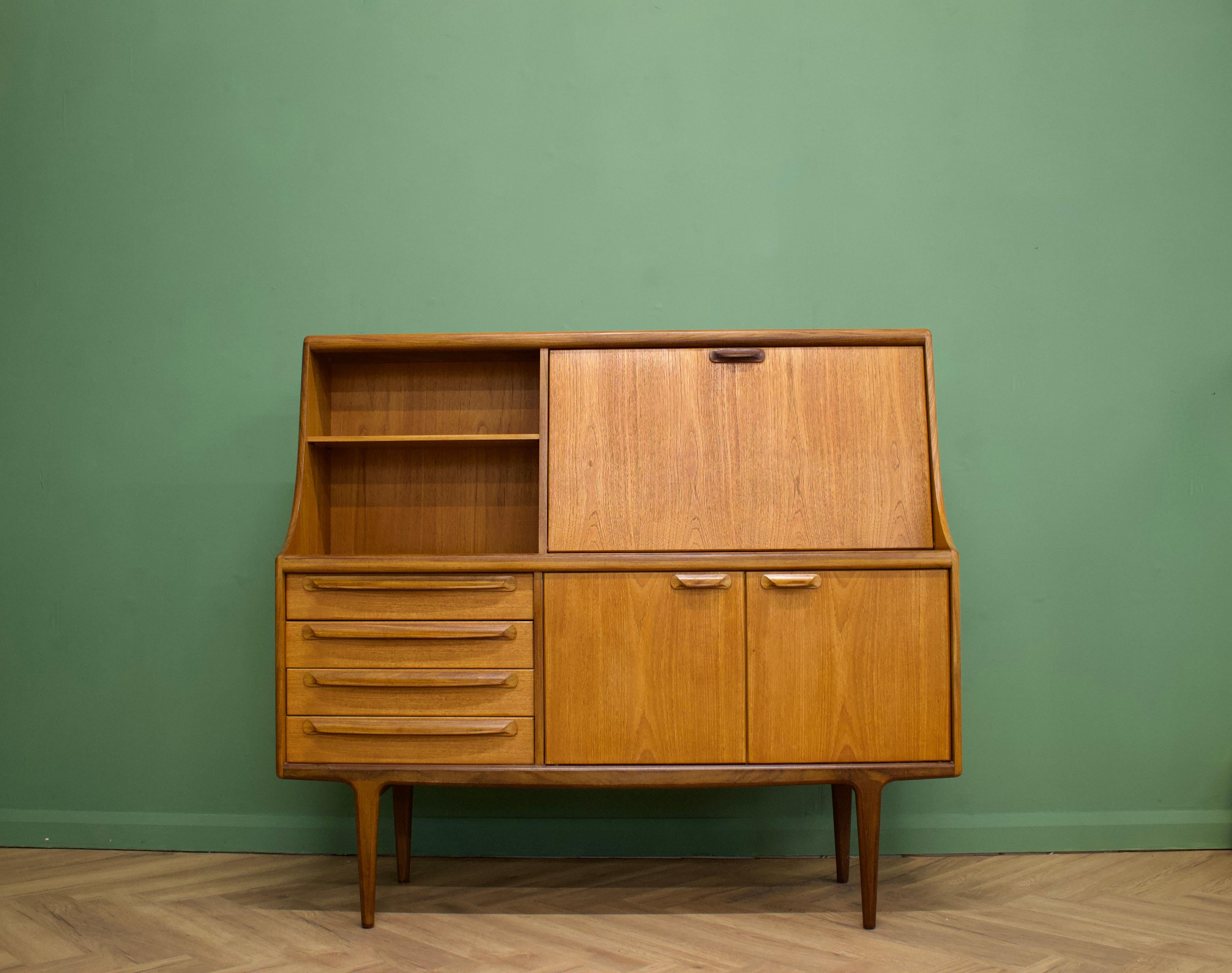 - Mid-Century Modern drinks cabinet / high sideboard.
- Manufactured in the UK by Younger.
- Made from teak and teak veneer.