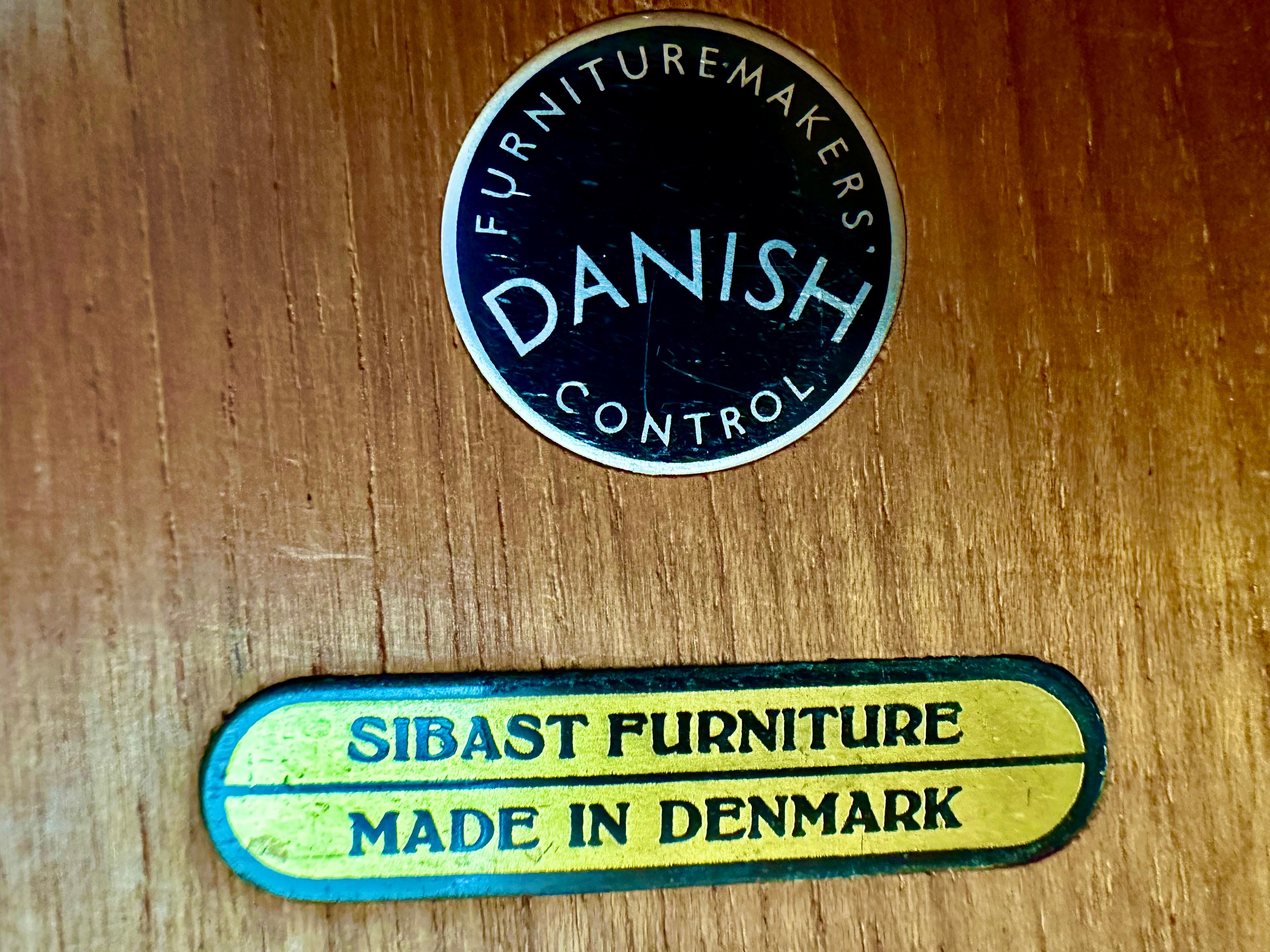 Gorgeous and very high quality sideboard designed by well known and top Danish designer Arne Vodder and produced by Sibast. Model name OS 36.

The sideboard features two tambour sliding doors, a normal door and 6 finely crafted drawers, altogheter