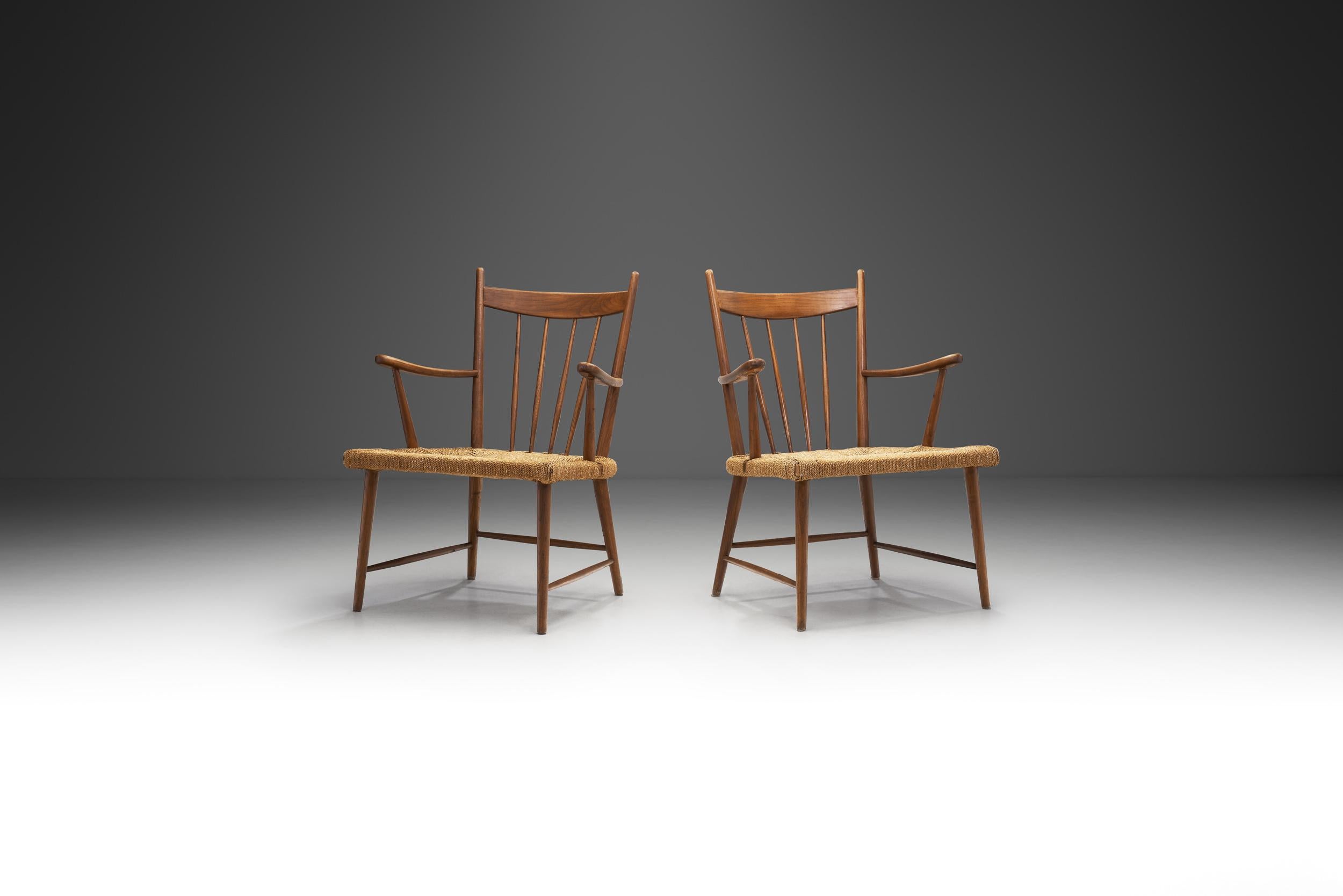 The designs of most of Danish mid-century modern furniture designers and architects aimed at functionality, an equally minimalist and appealing appearance and easy accessibility. This pair of slatback chairs with woven Danish paper cord seats is