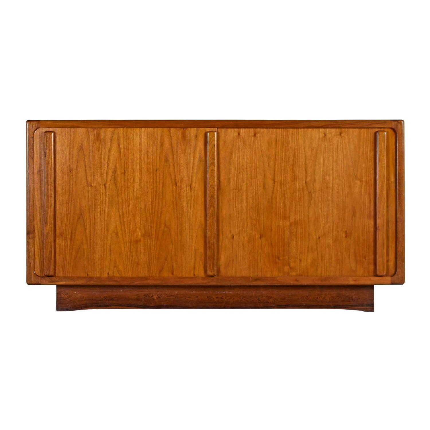 Expertly crafted vintage teak credenza. The unit features convenient sliding doors that conceal cabinet space to the left and right. Use it as a dresser in the bedroom, TV stand in the living room or buffet in the dining room. Tons of room for
