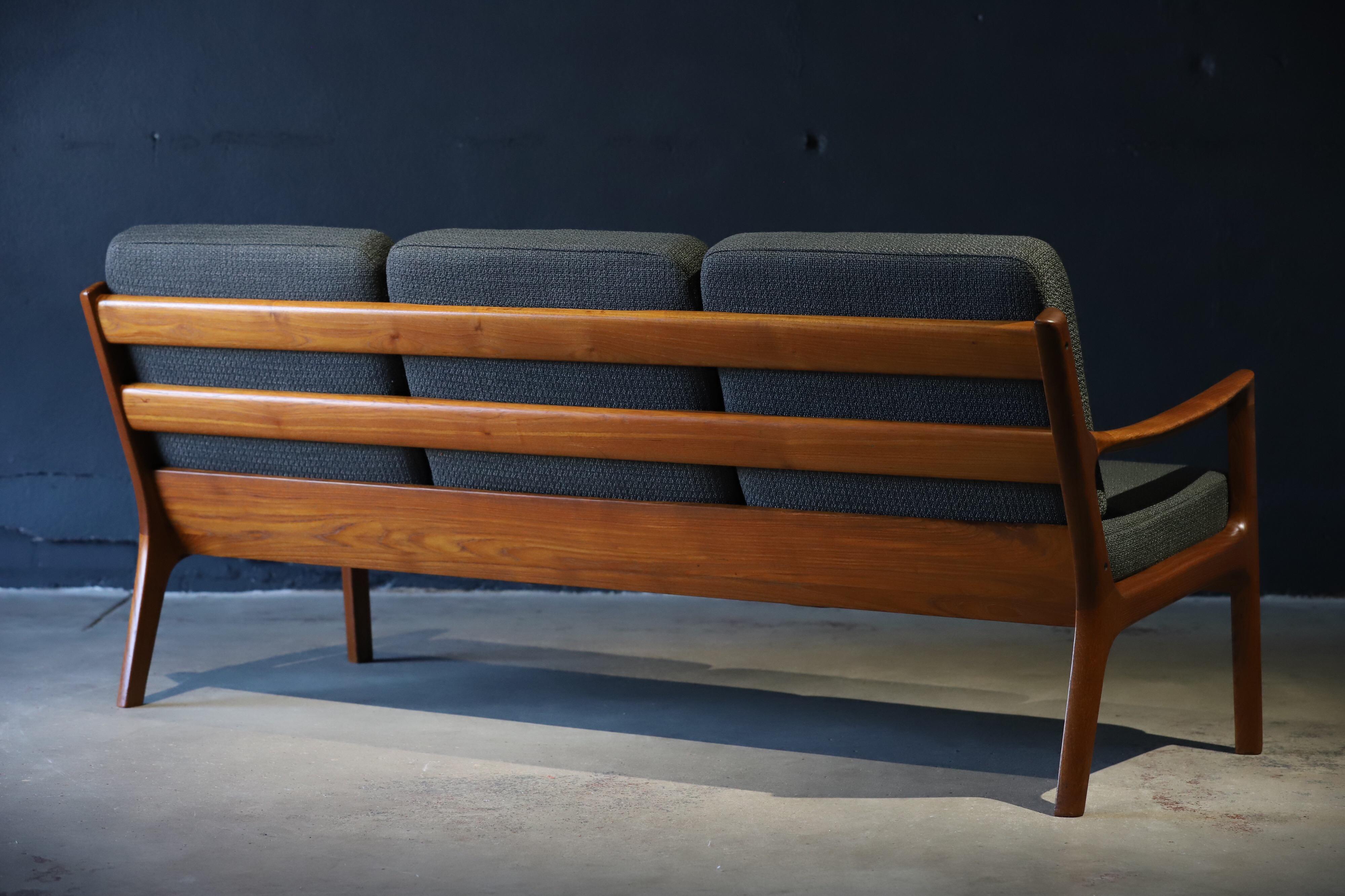 Stunning teak sofa with fresh upholstery designed by Ole Wanscher for France and Son. Photographed with biomorphic table and Ole Wanscher armchair for scale.