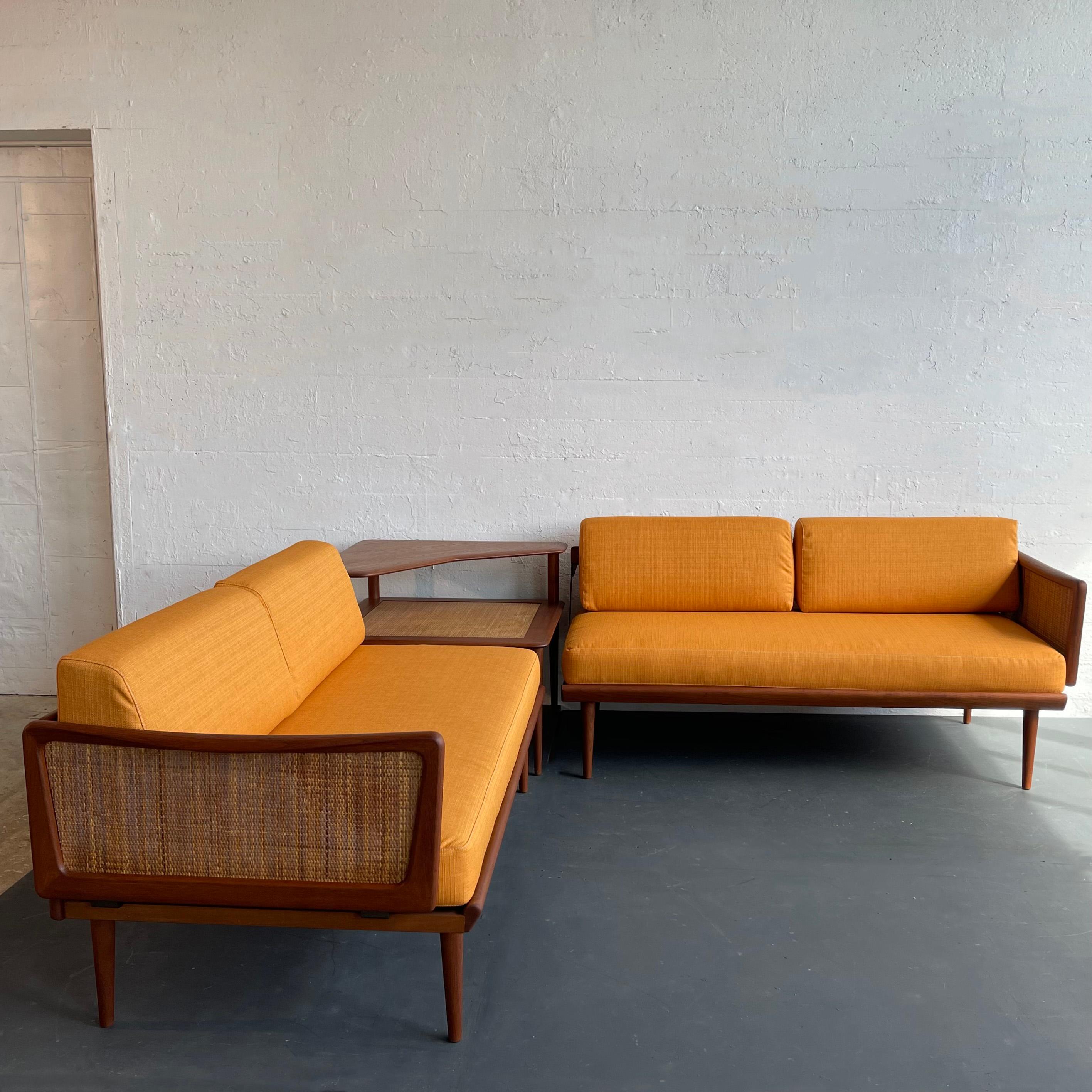 Scandinavian modern, teak, three piece sectional seating set designed by Danish architects Peter Hvidt & Orla Mølgaard-Nielsen for France And Son and retailed by John Stuart in the U.S. includes two sofa daybeds and the FD 519 tiered corner table.
