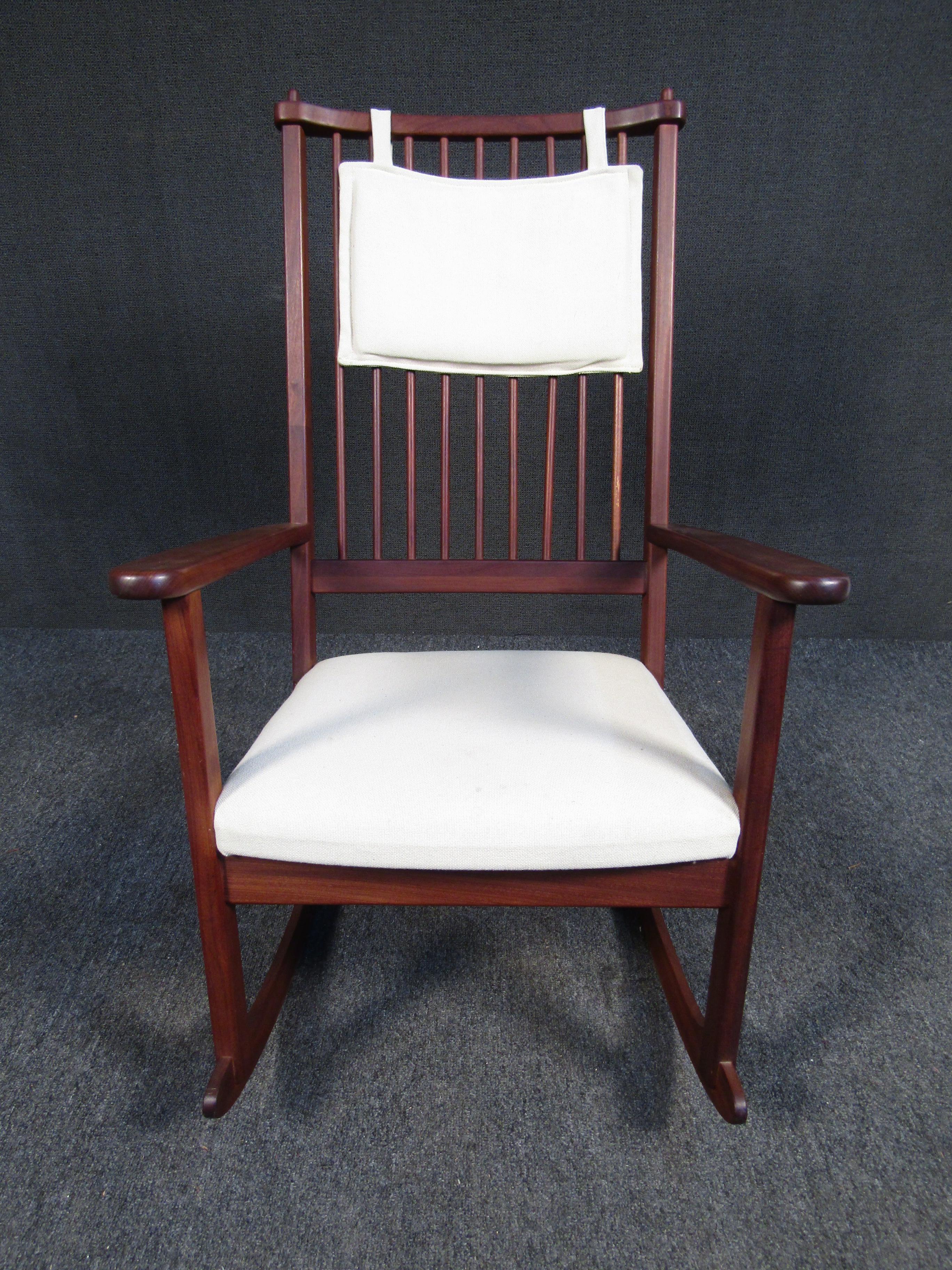 With dark and rich teak wood grain, timeless design, and contrasting light colored upholstery, this vintage rocking chair is a stylish way to add Mid-Century Modern style to space.
Please confirm location NY or NJ