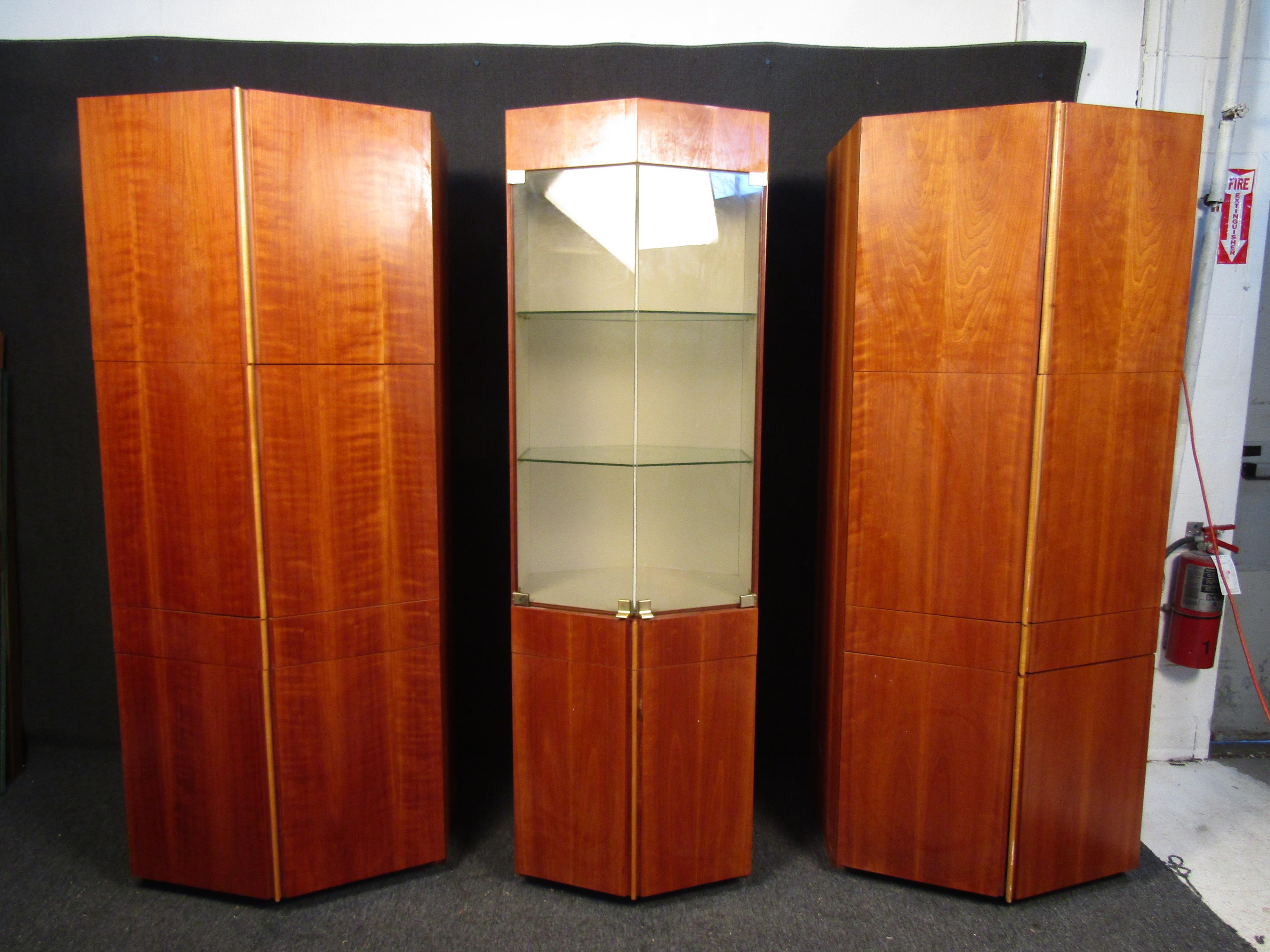 These unique Dillingham china cabinets come in a set of three. The two end cabinets are identical with all wood doors and glass shelving. The middle cabinet features two glass doors and a light up show area. If you are looking to furnish a dining