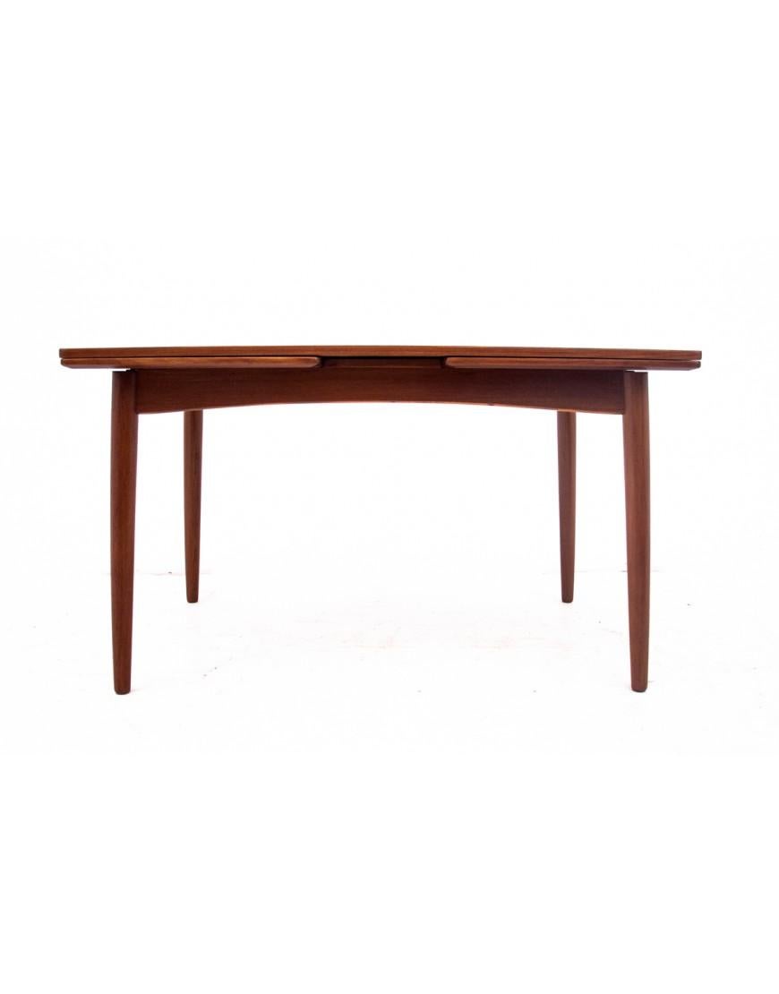 Teak table, Denmark, 1960s.

A table with the possibility of extension, on the sides it has two extendable tops. The delicately profiled table top adds lightness to the whole form. Very good condition, after professional renovation. The surface has