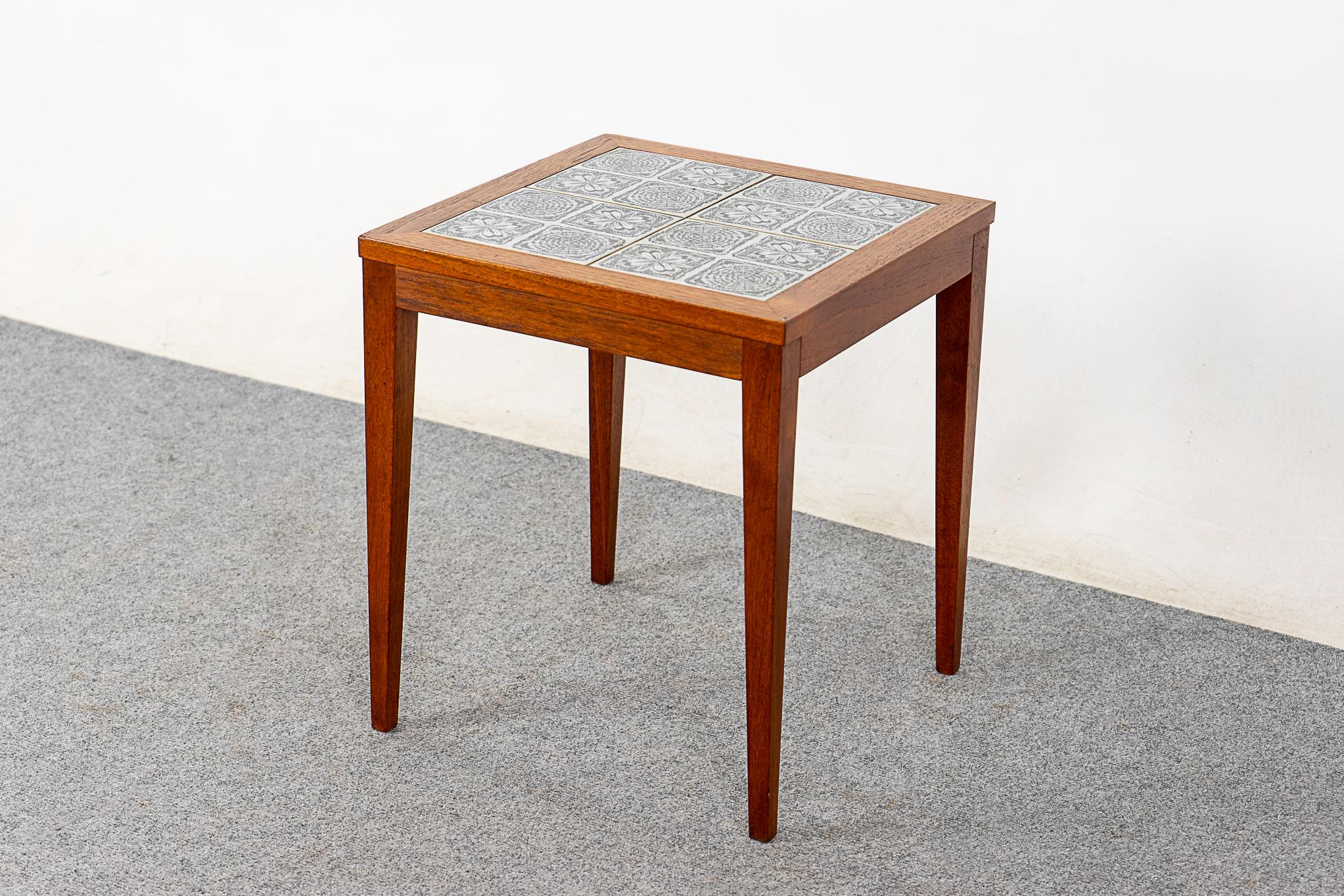 Teak & tile mid-century side table, circa 1960's. Clean lines, tapered legs and a compact profile! The decorative alternating tiles contrast beautifully with the warm tone of the frame. Pop this beside your comfy lounger, voila!

Please inquire for