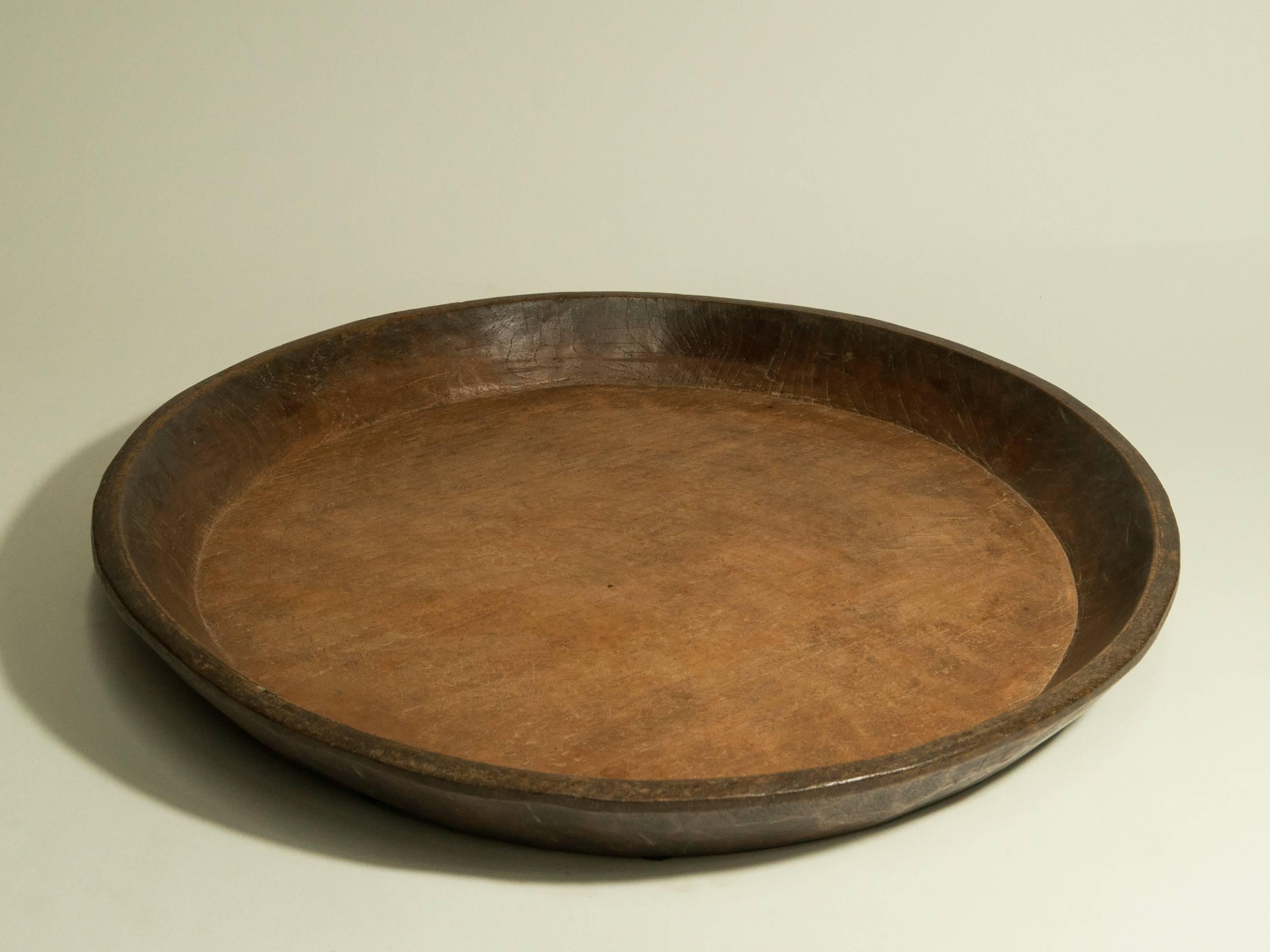 Vintage Hand-Hewn Teak tray from Java. 19 inch diameter. Mid-20th century.
Fashioned from a single piece of teak.
The tray is in excellent condition.
Dimensions: 19 inches diameter by 2 inches high.