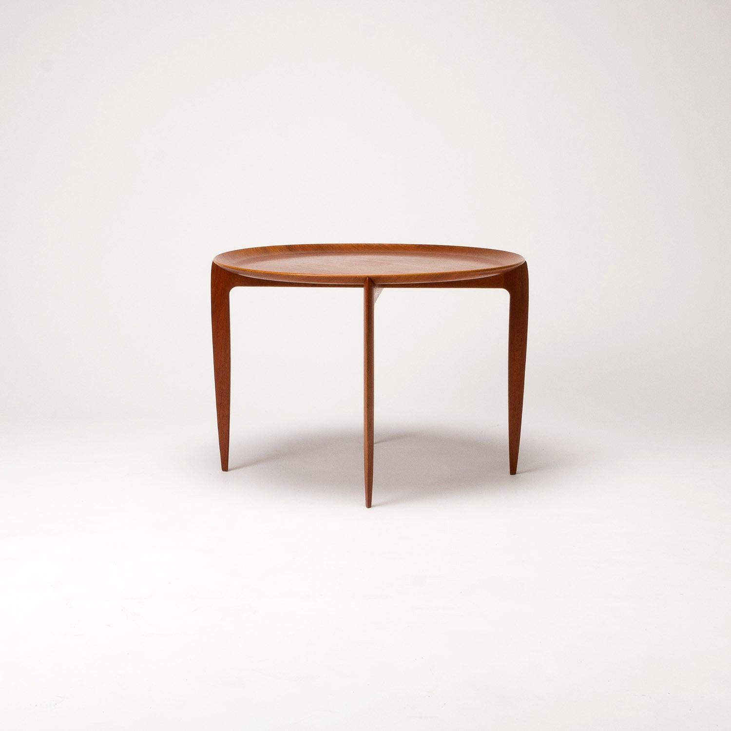A folding teak tray table designed by H Engholm and Svend Åge Willumsen for Fritz Hansen, Denmark, made in 1966. Great patina and condition.
    