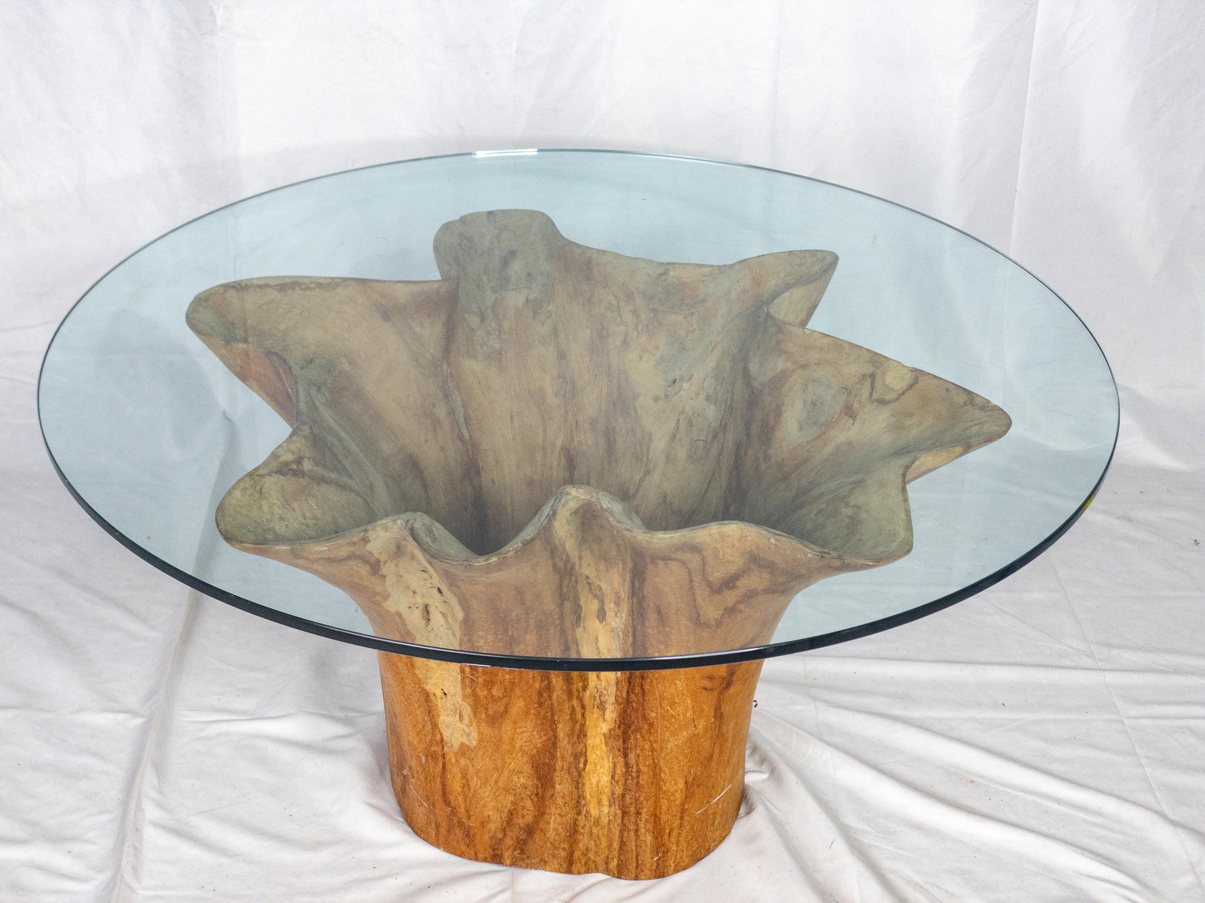 The Teak Tree Trunk Coffee Table is a stunning piece of furniture that seamlessly blends the raw beauty of nature with functional design. Crafted from a teak tree trunk, it celebrates the innate elegance of organic forms. The trunk's natural shape,
