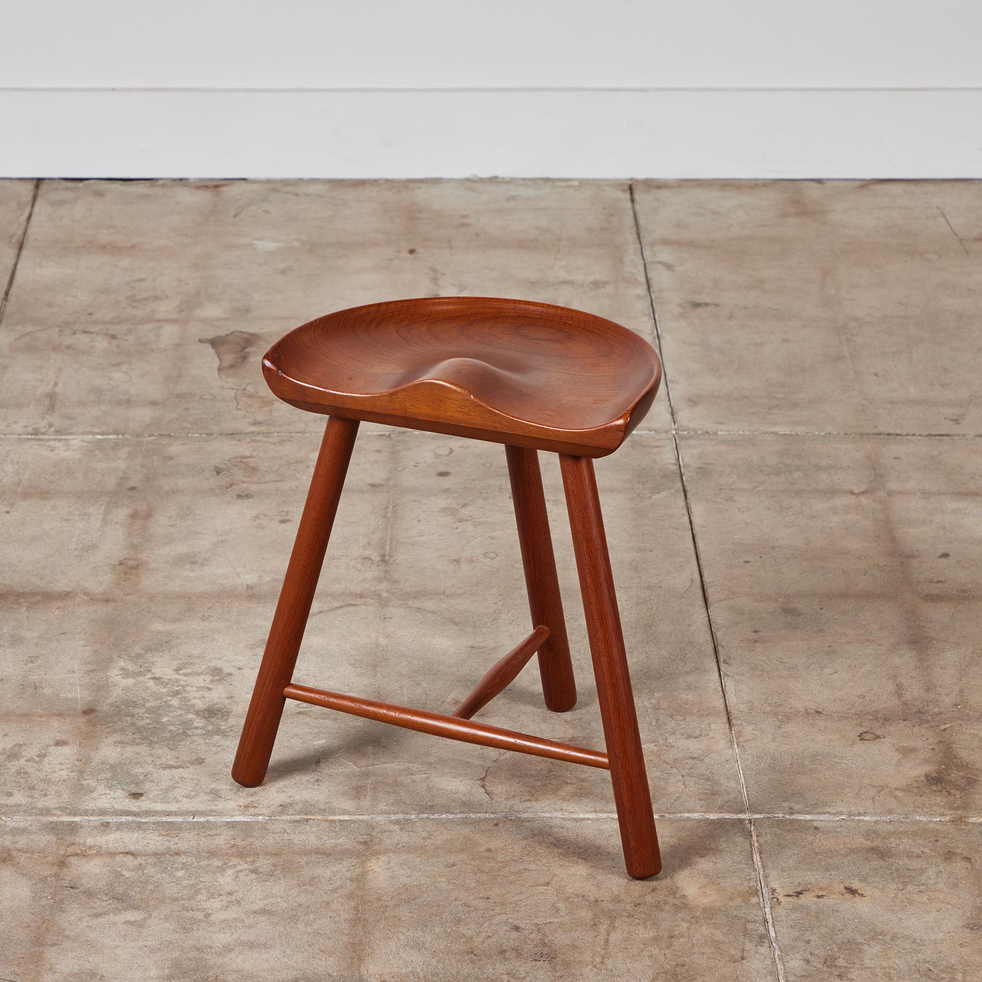 Teak tripod milking stool. The stool features a thick hand carved rounded seat that sits atop three teak turned legs with stretchers.

Dimensions
18