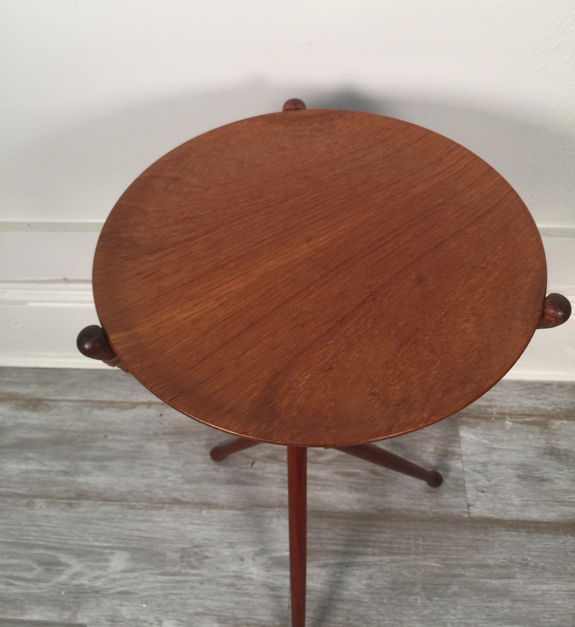 Collapsible tripod table with removable top by Nils Trautner for Ary in teak and brass with leather supports, Swedish, 1950s.